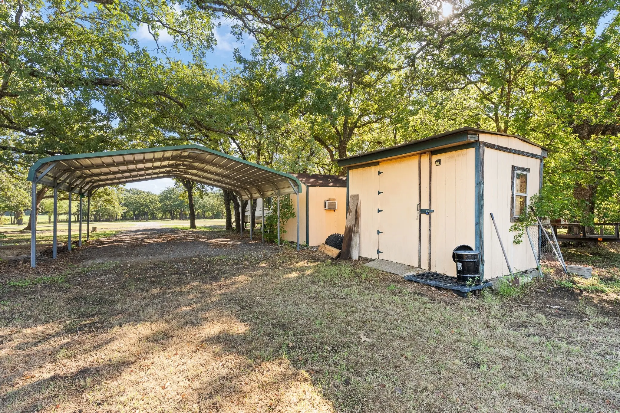 two storage workshops with electric and a 2 car carport for covered parking.