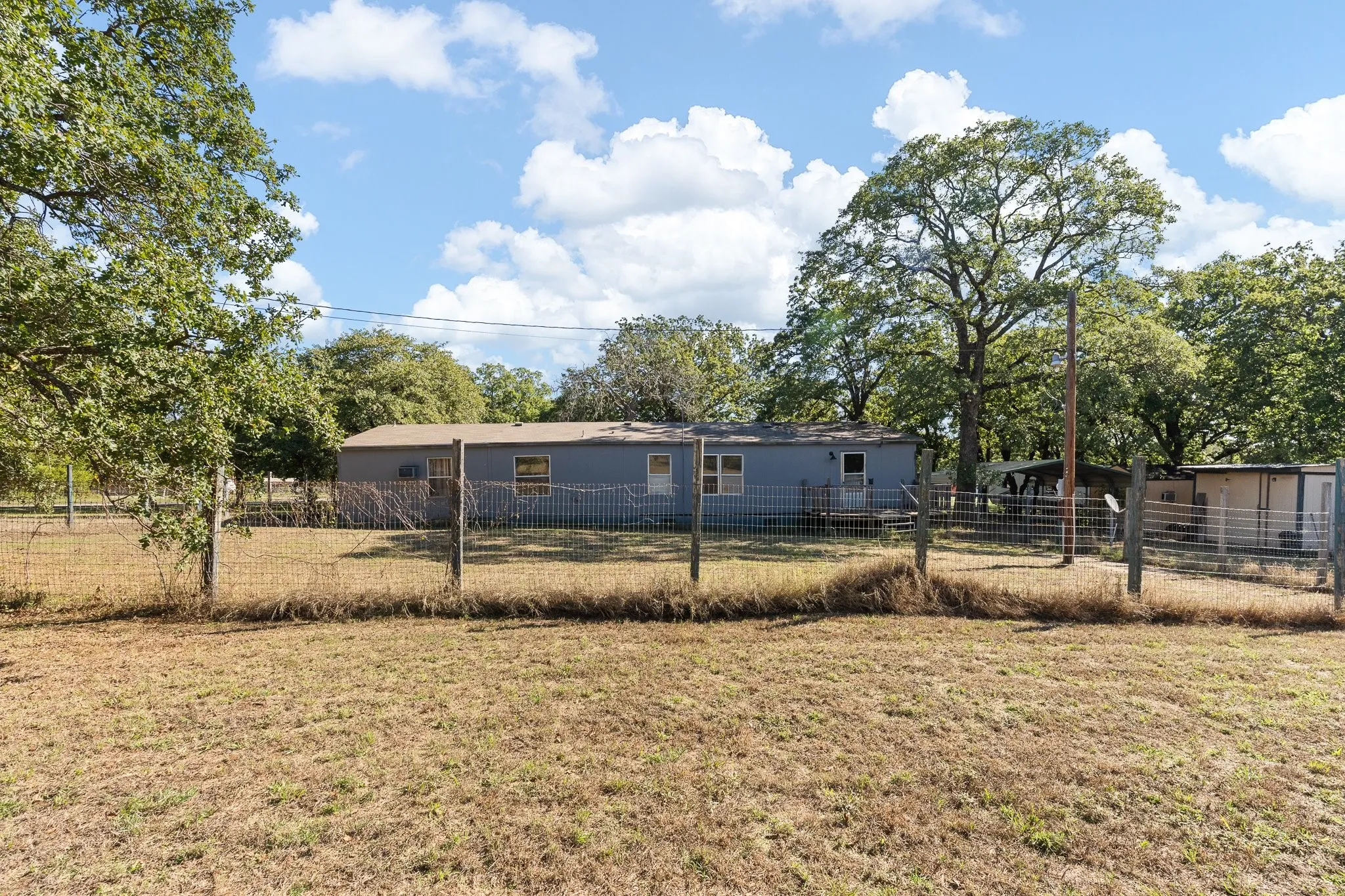 View of fully fenced backyard.
