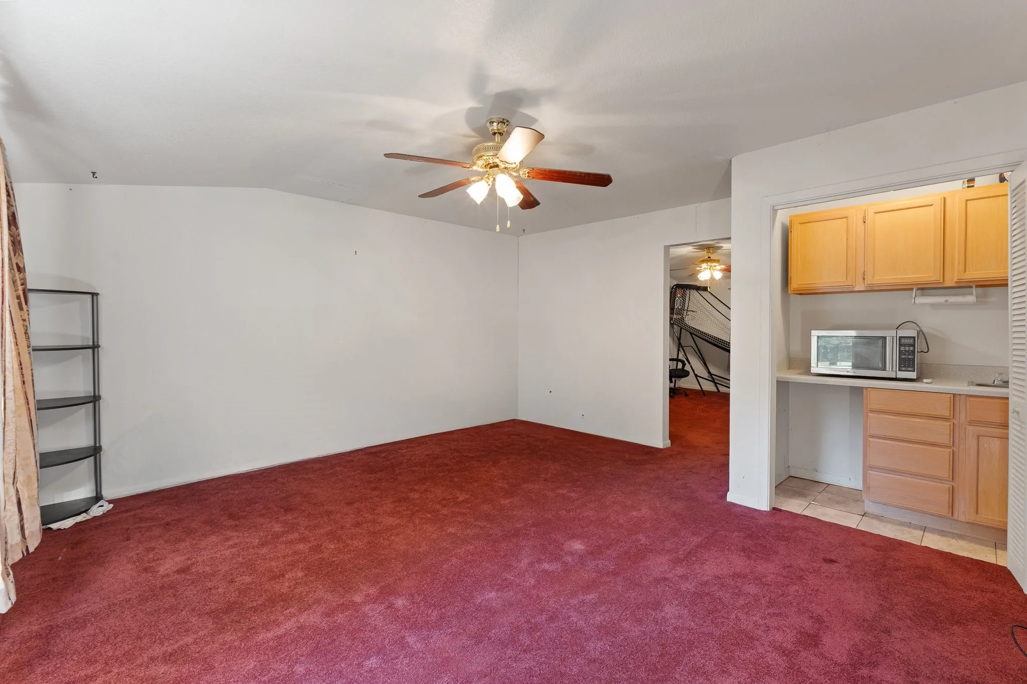Mother in Law Suite living room with ceiling fan and window unit for cool air.