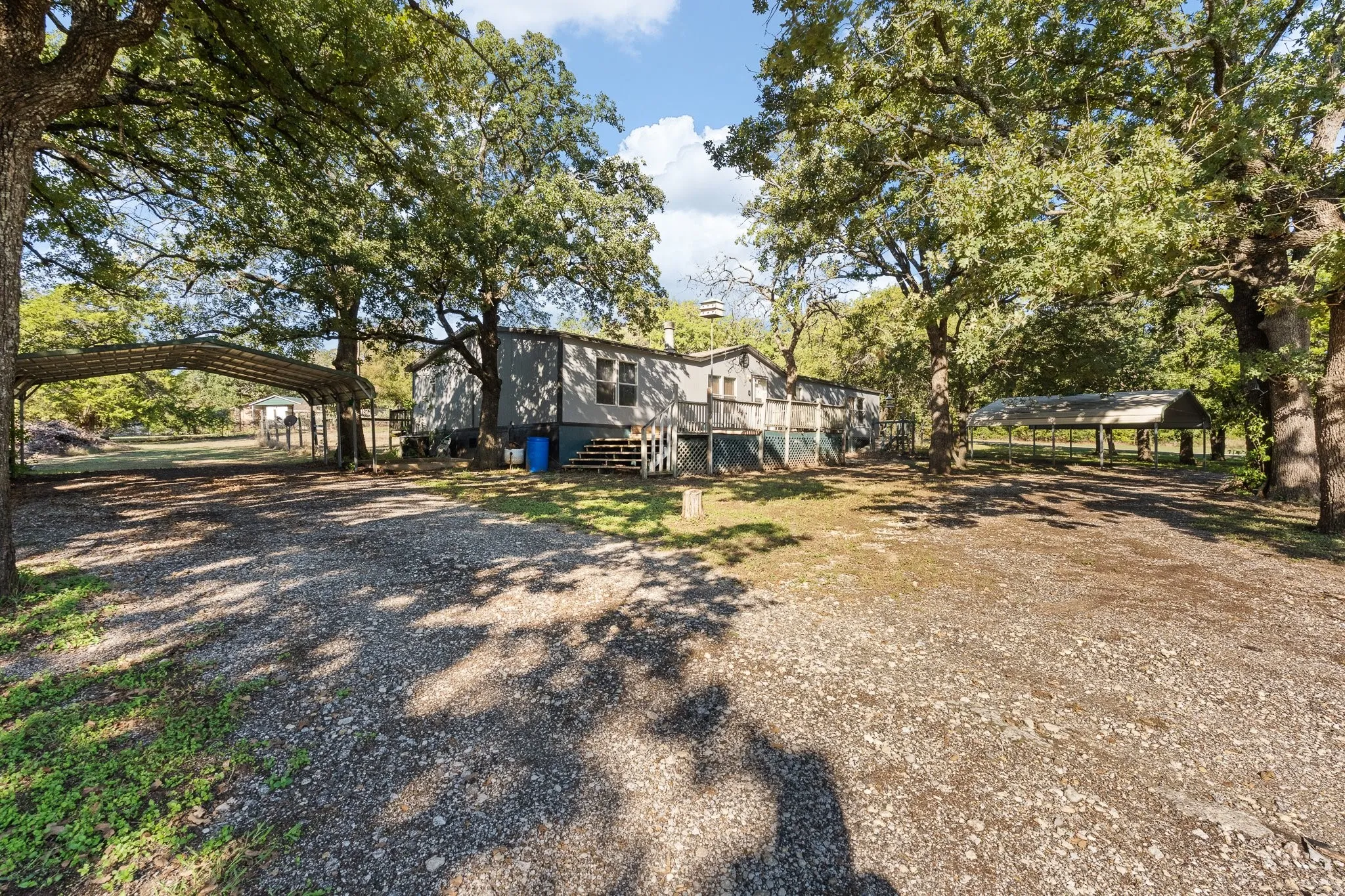 View of front of home with two carports for four additional covered parking spaces.