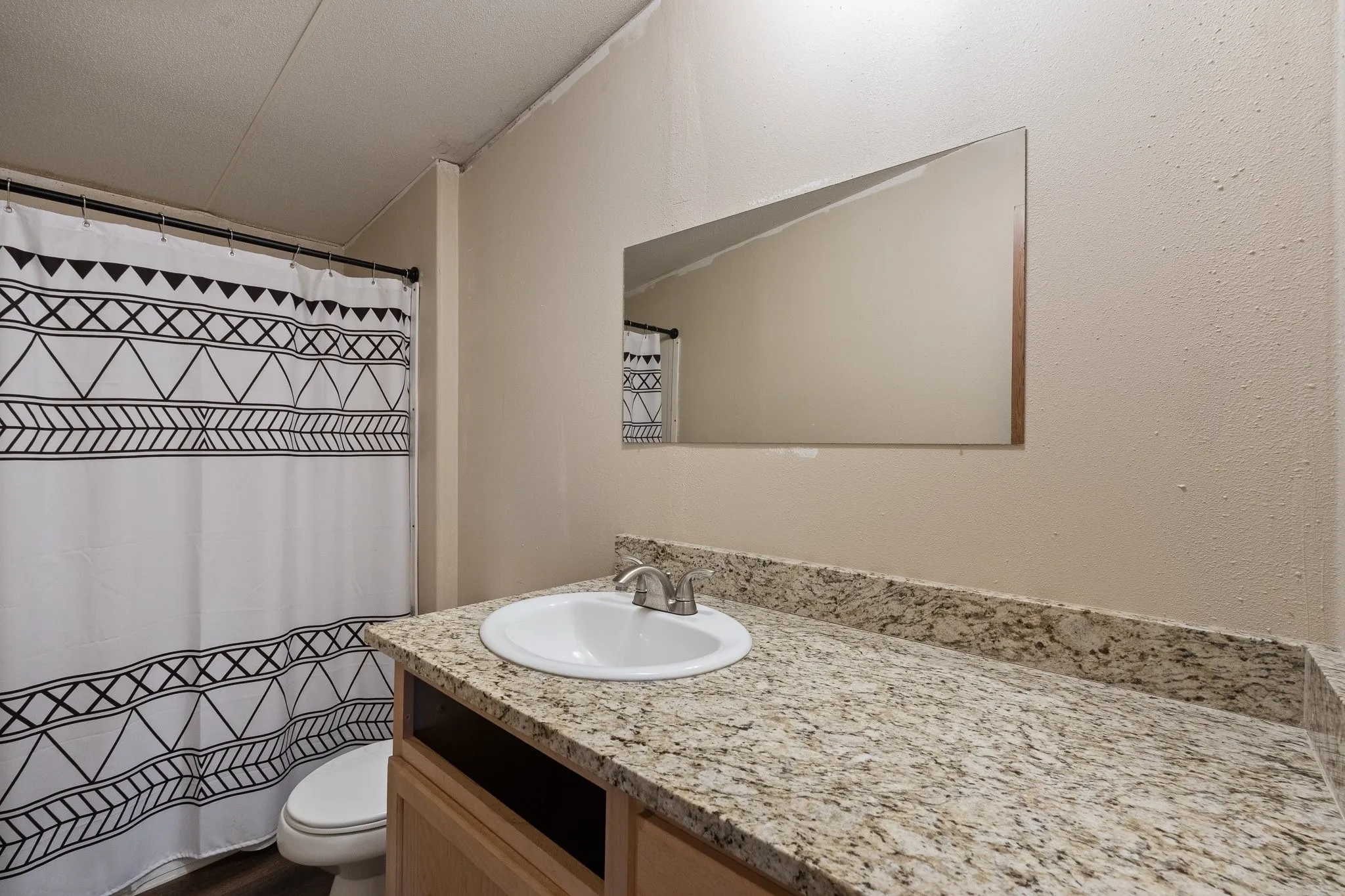 Guest Bathroom with large oversized vanity and tub/shower combo.