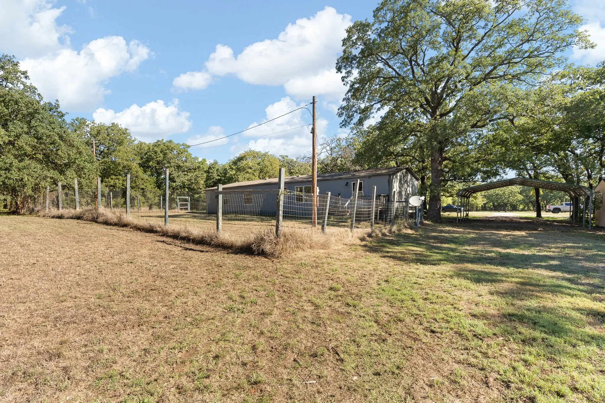 View of fully fenced backyard.