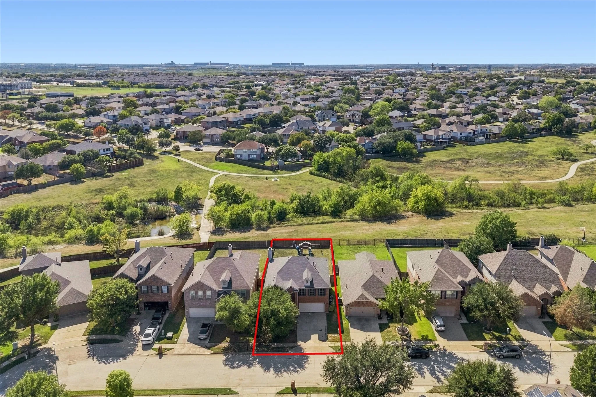 Residential property featuring a shingled roof and attached garage