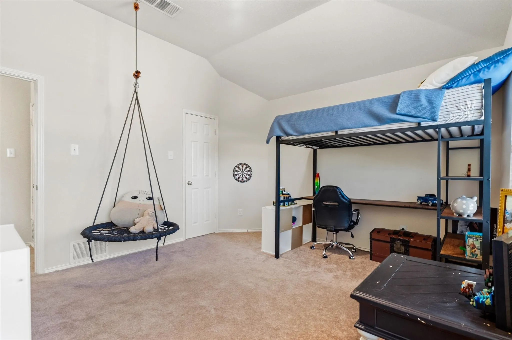 Carpeted flooring, vaulted ceiling, and white painted walls