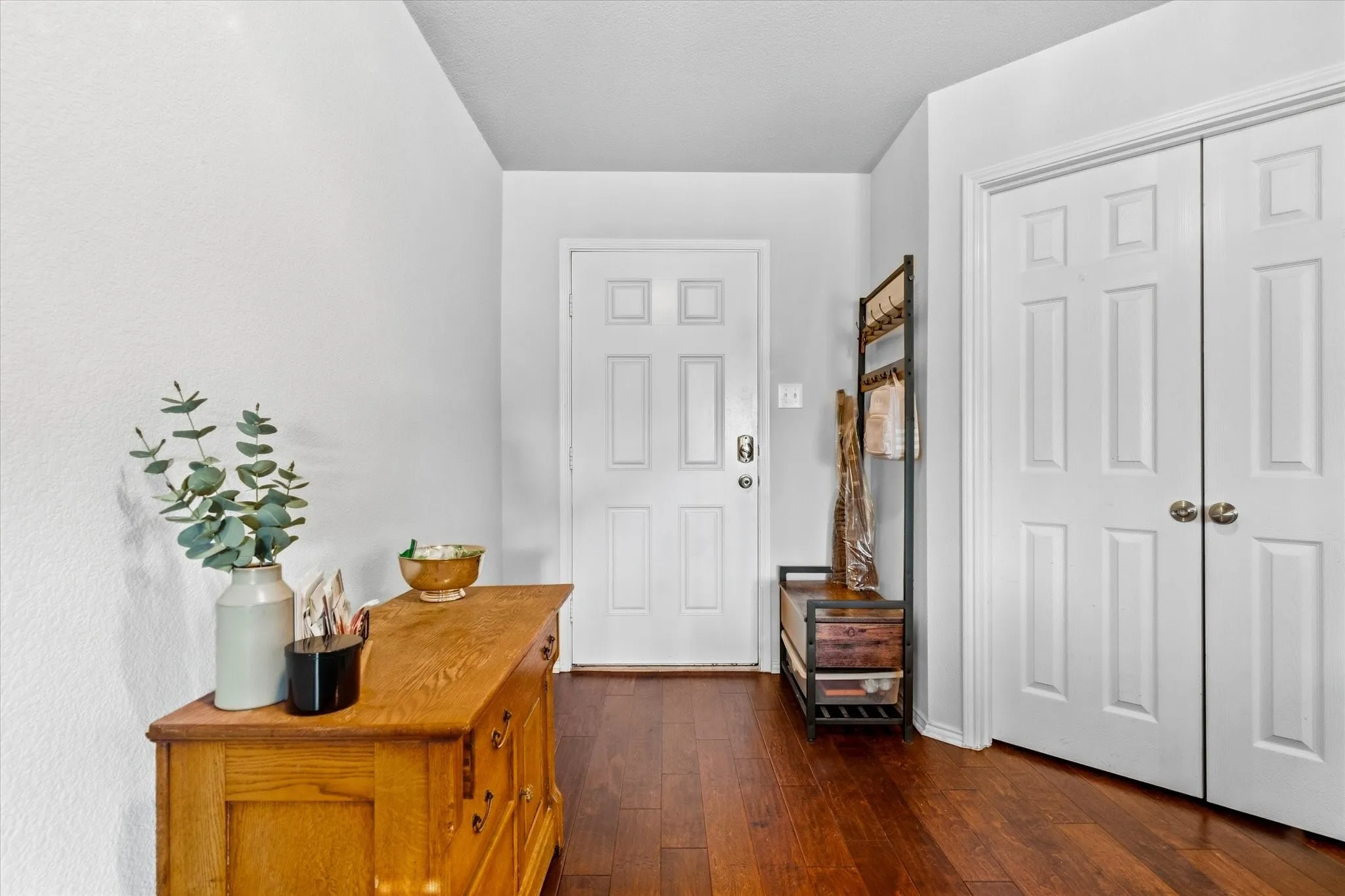 Warm wood-finish flooring with white walls