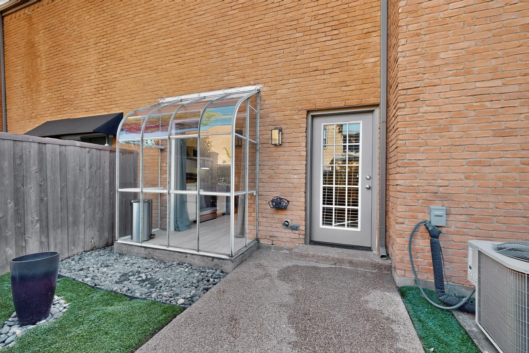 Brick exterior with a glass-paneled entry door