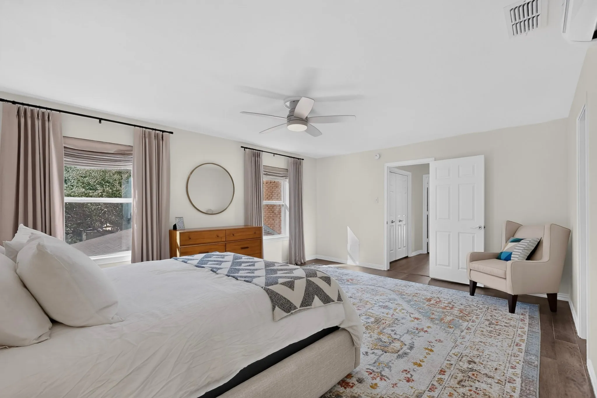 Spacious room with multiple windows and light-toned walls