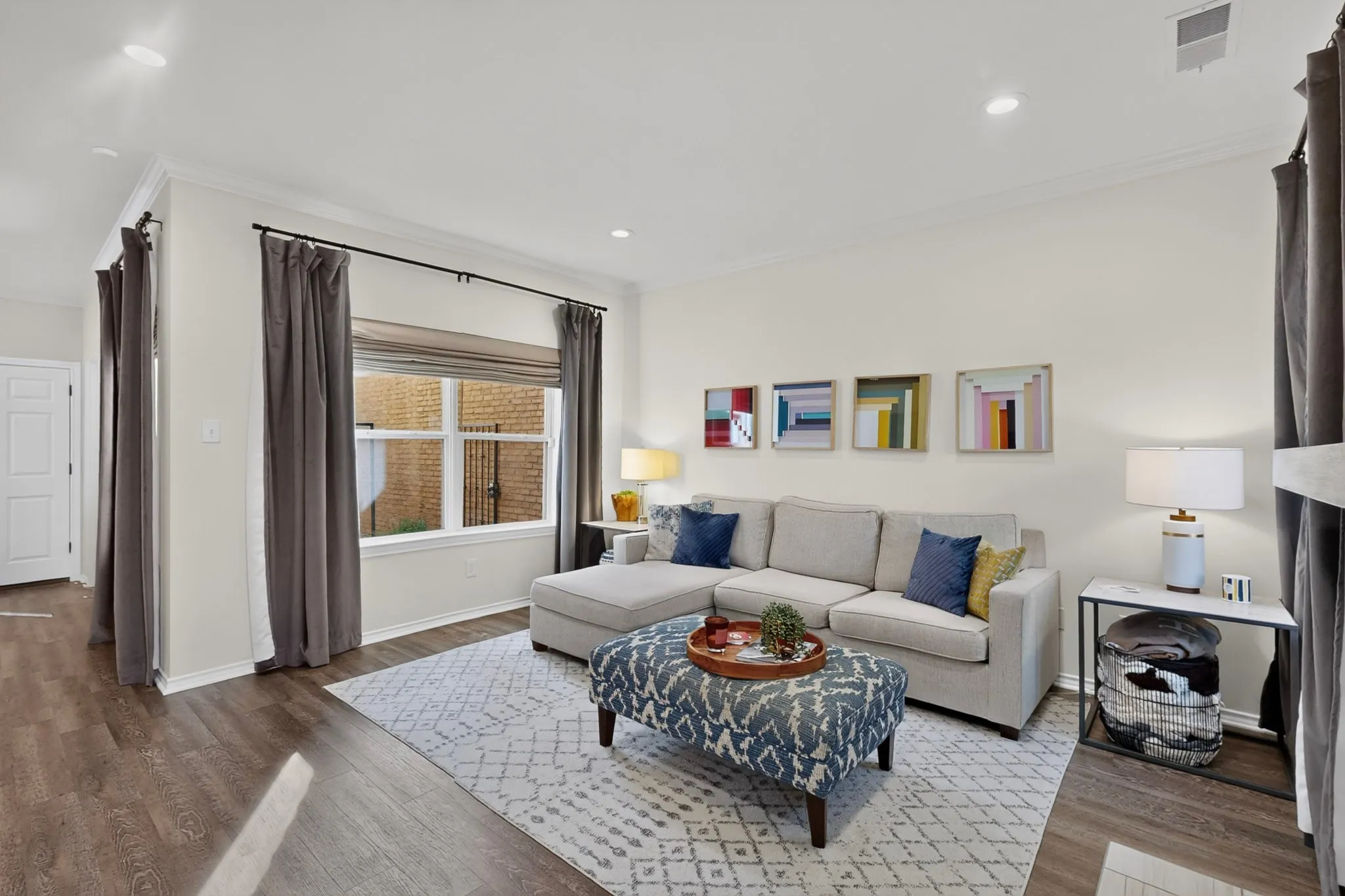 Wood-finish flooring, recessed lighting, crown molding, double-pane window, and white interior doors