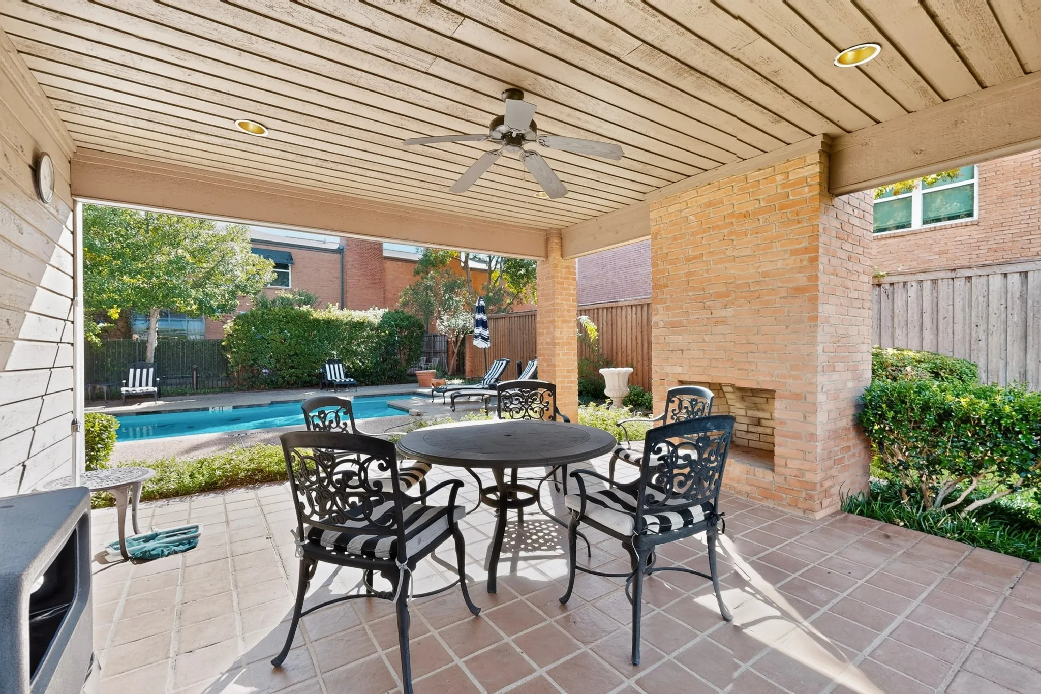 Community covered patio with a wood-plank ceiling, recessed lighting, and a ceiling fan