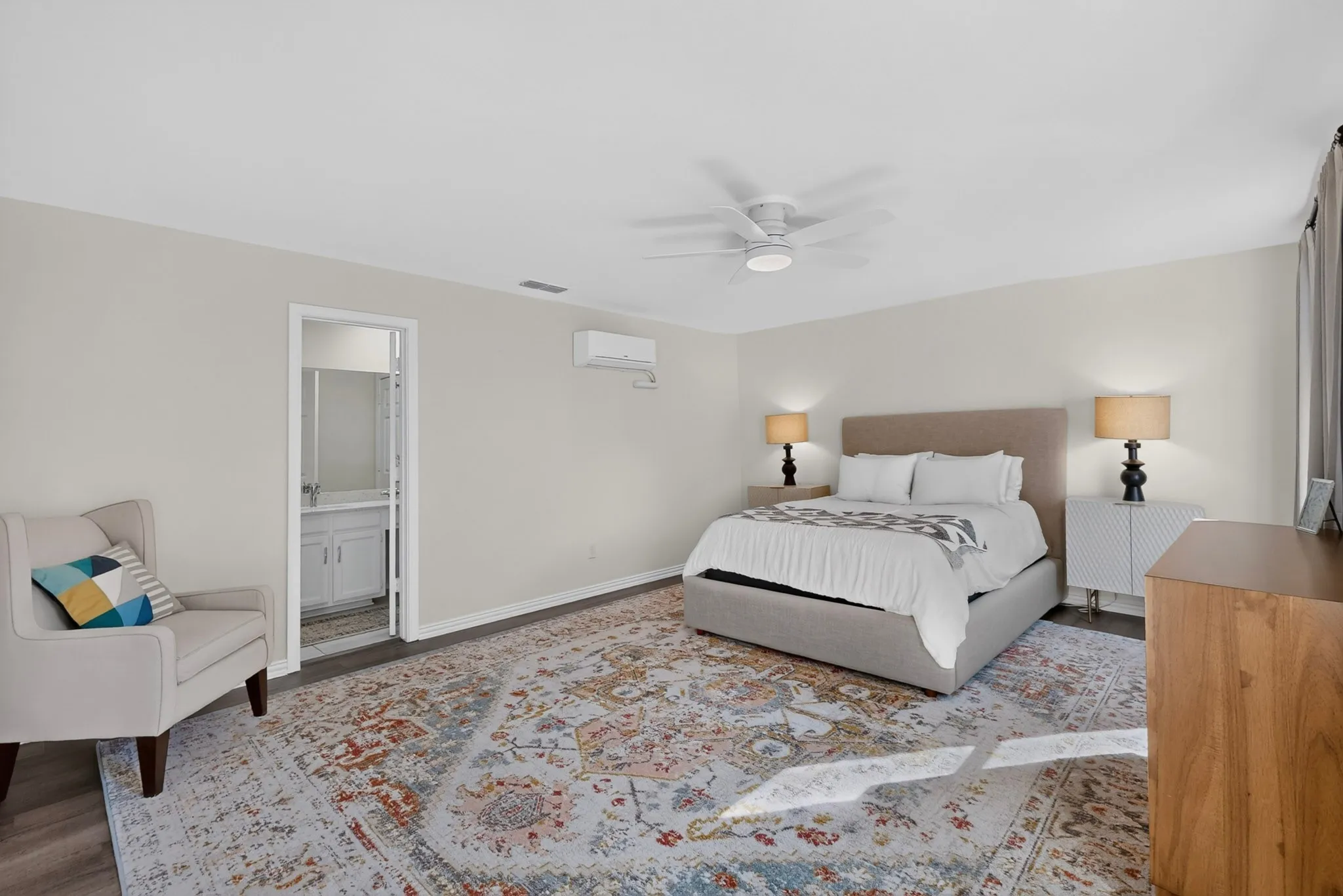 Neutral wall tones with dark wood-finish flooring