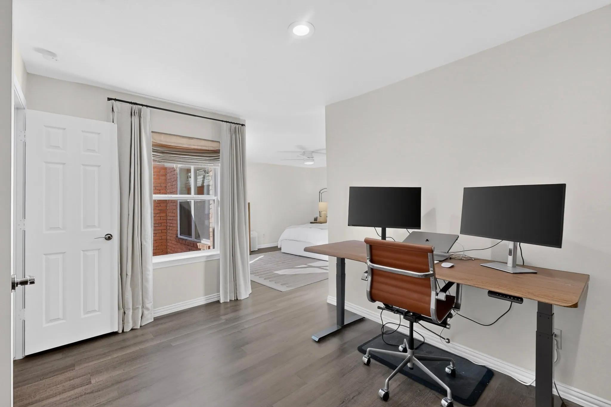 Recessed lighting, wood-finish flooring, paneled interior doors, and a window with blinds