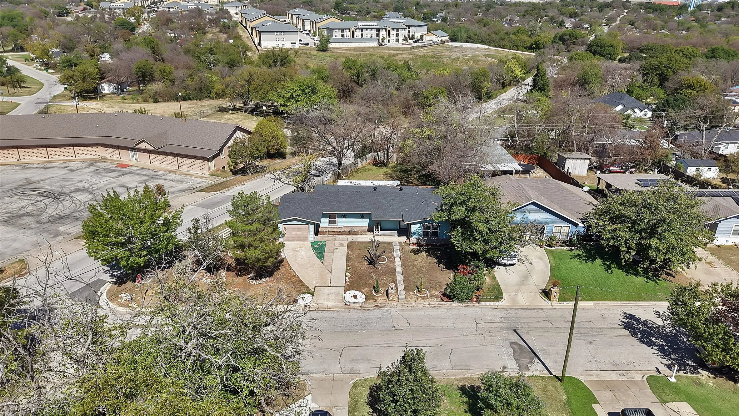 Single-story residence with a dark roof and light-colored exterior