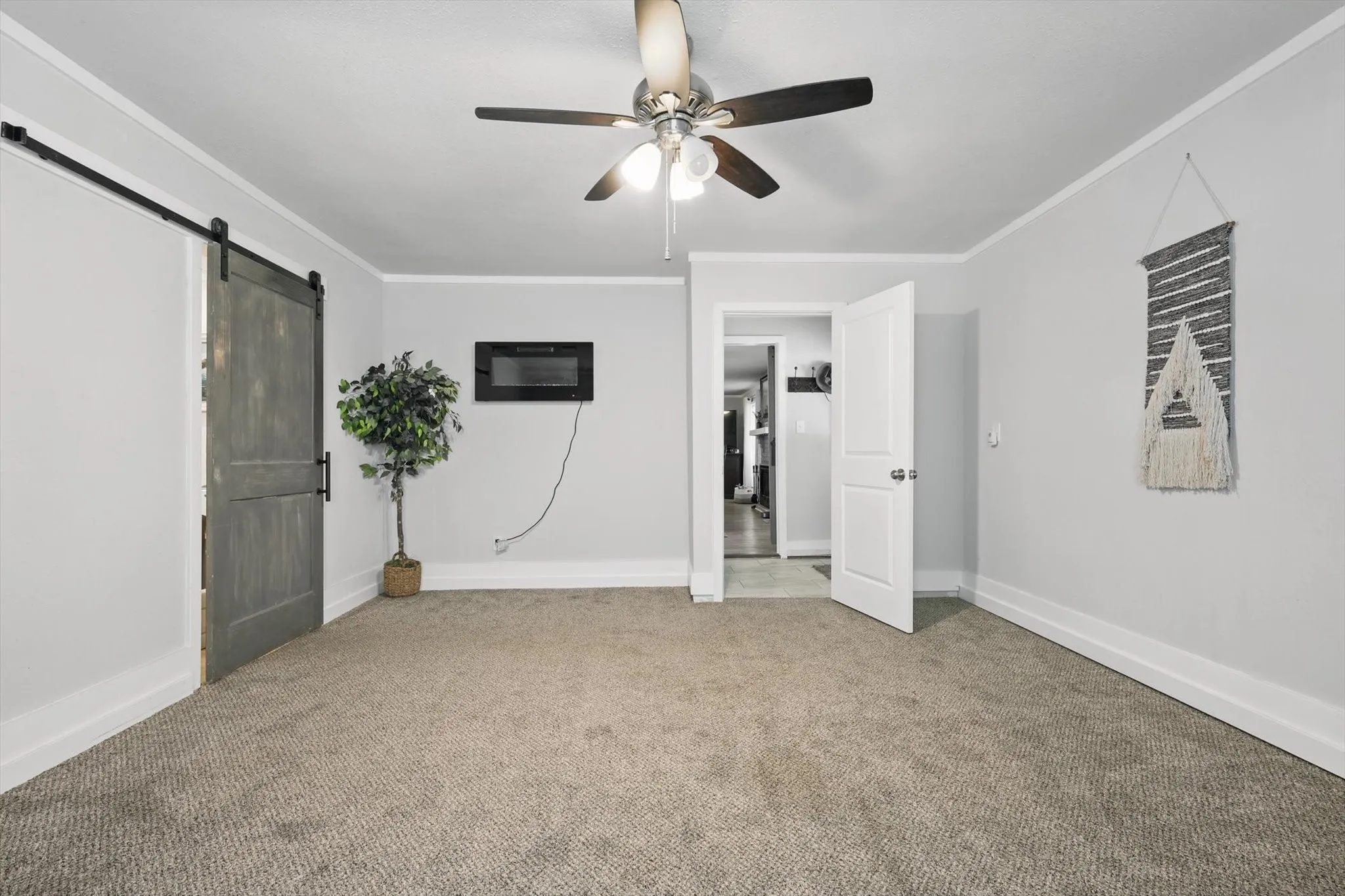 Neutral-toned carpet flooring, light gray wall paint, and white trim