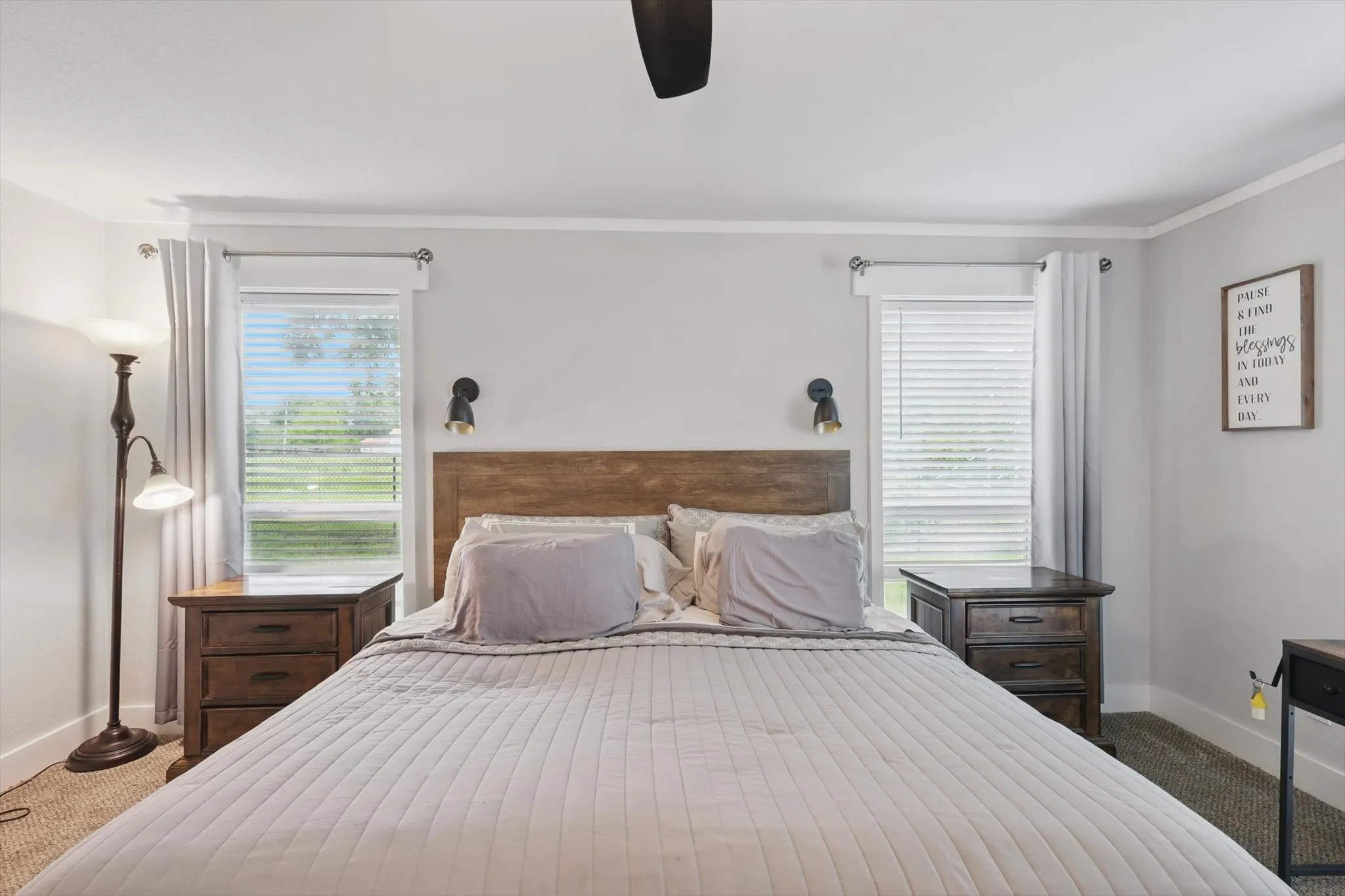 Recessed lighting, wood-finish flooring, two windows with blinds, crown molding, and wall-mounted sconces