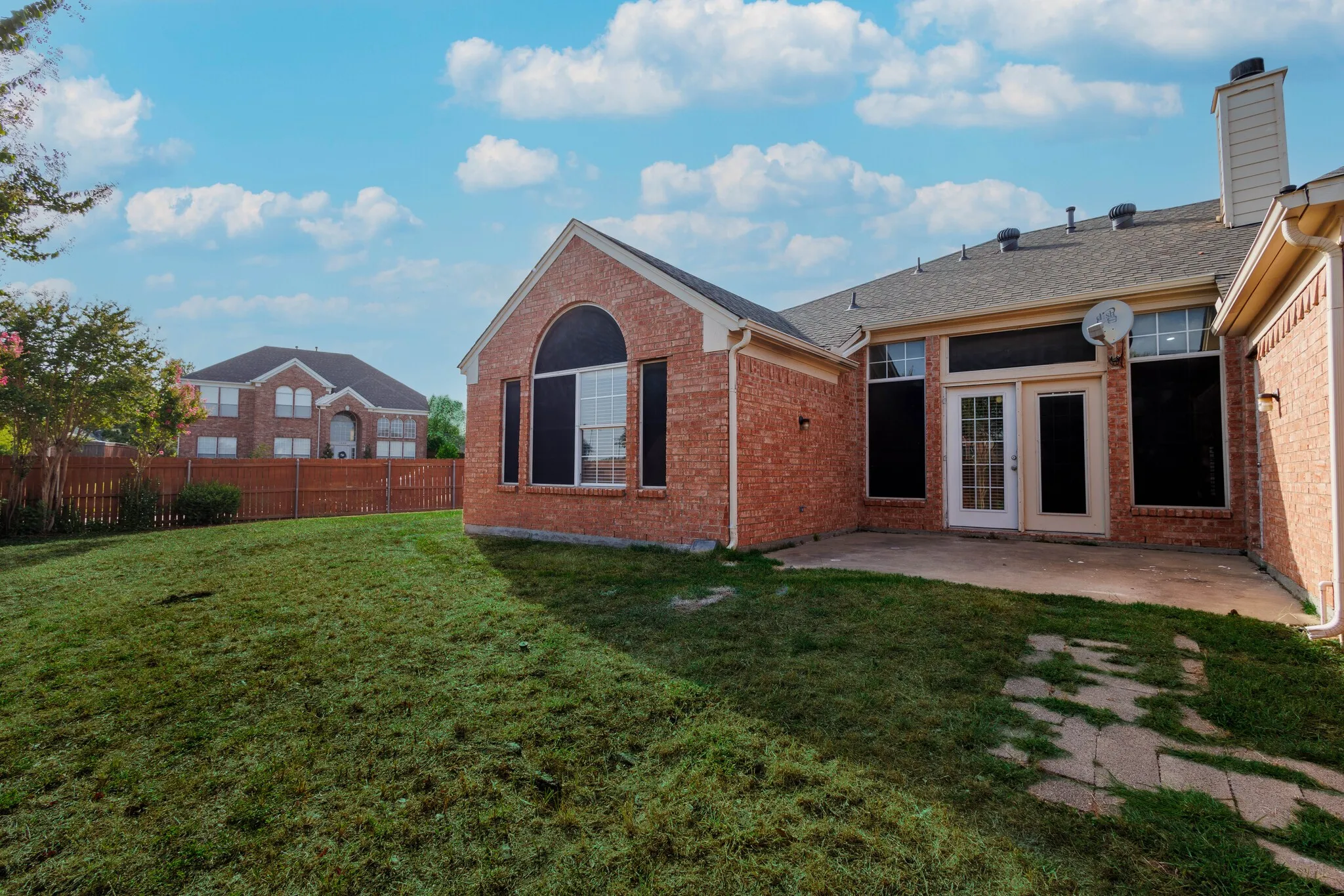 Back of property with a patio and a lawn