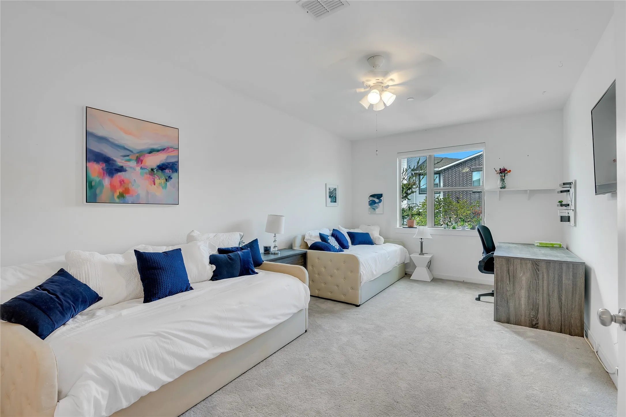 Recessed lighting, ceiling fan, expansive window, built-in shelving, and light gray carpeting