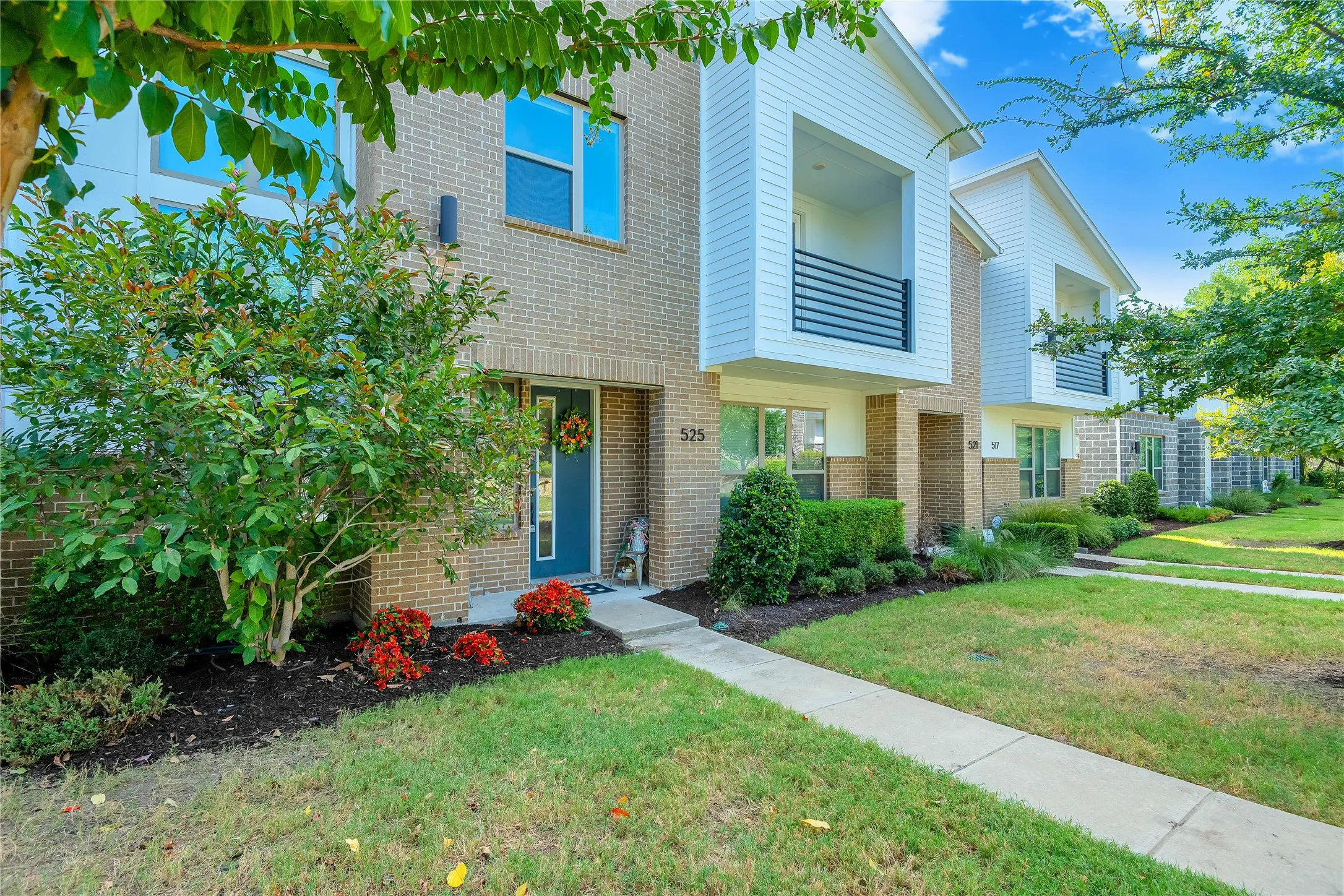 Brick and horizontal siding exterior with a dedicated front walk and landscaped entry