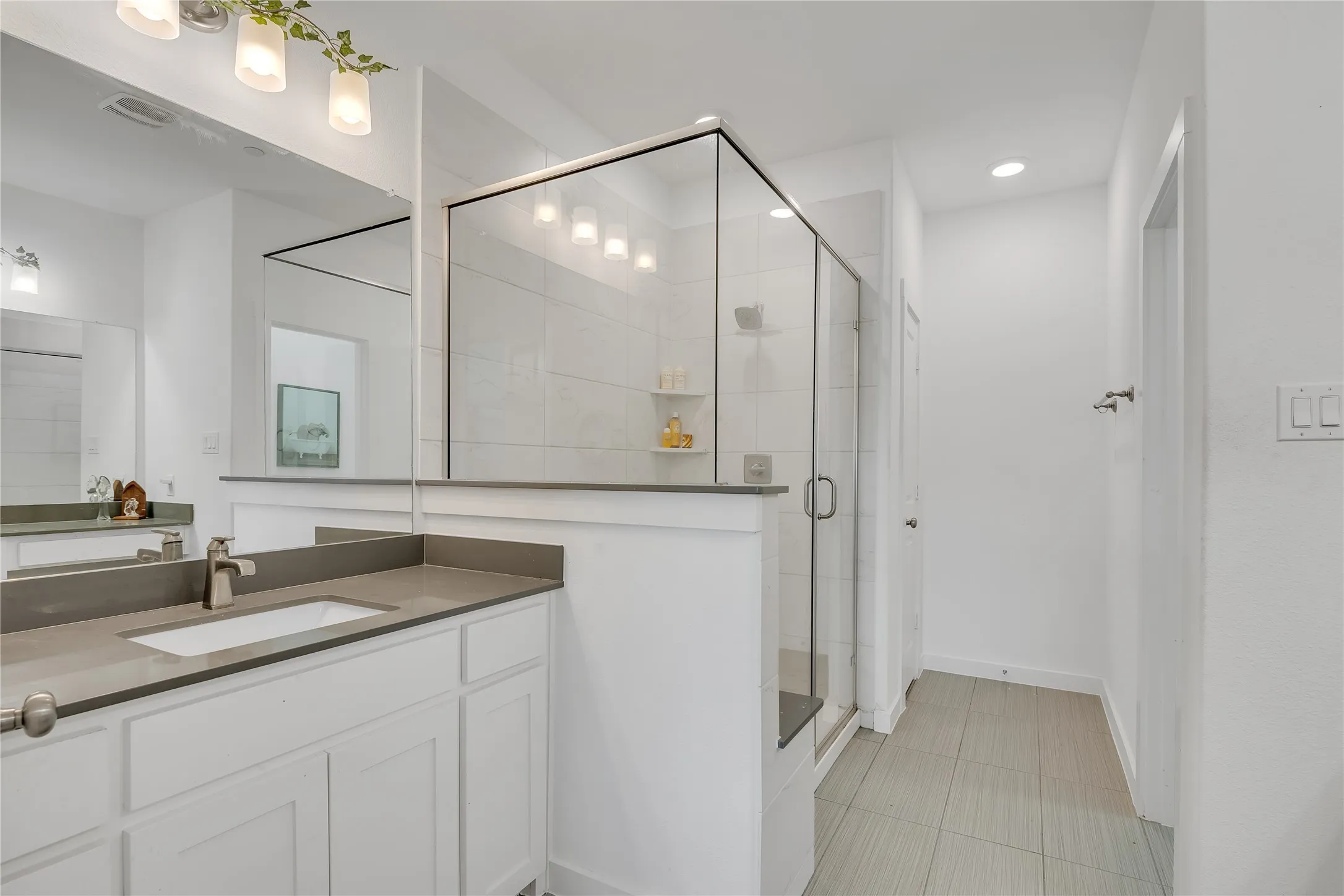 White vanity with an integrated sink and brushed nickel faucet