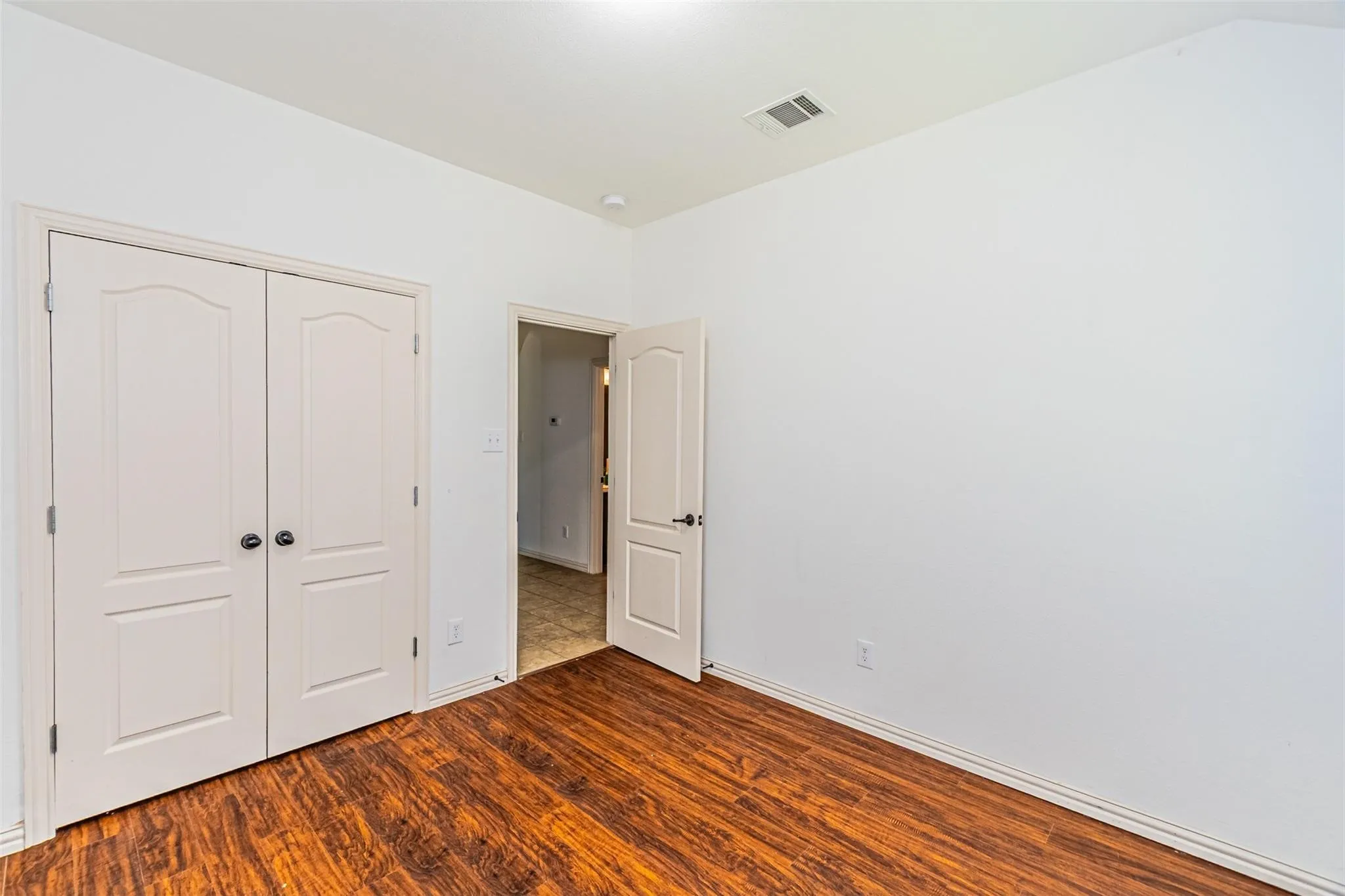 Wood-finish flooring with a satin sheen and a light-colored wall paint