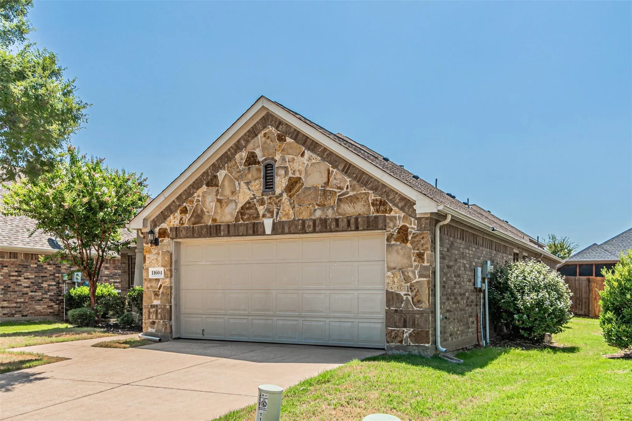 Stone and brick exterior with a two-car garage
