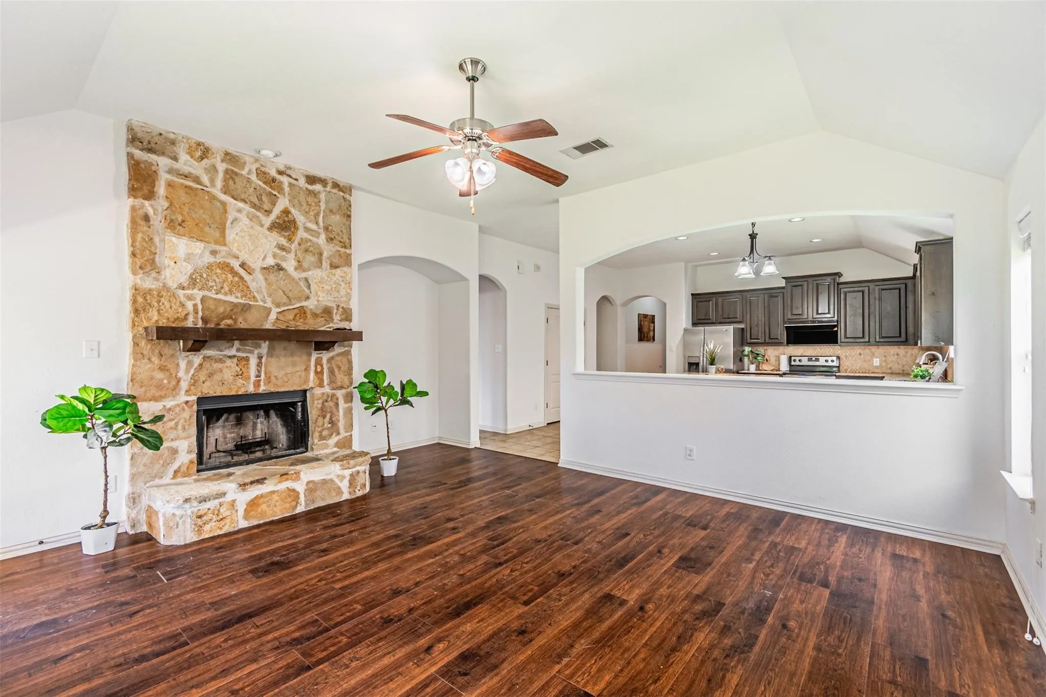 Stone-clad fireplace with wood mantle