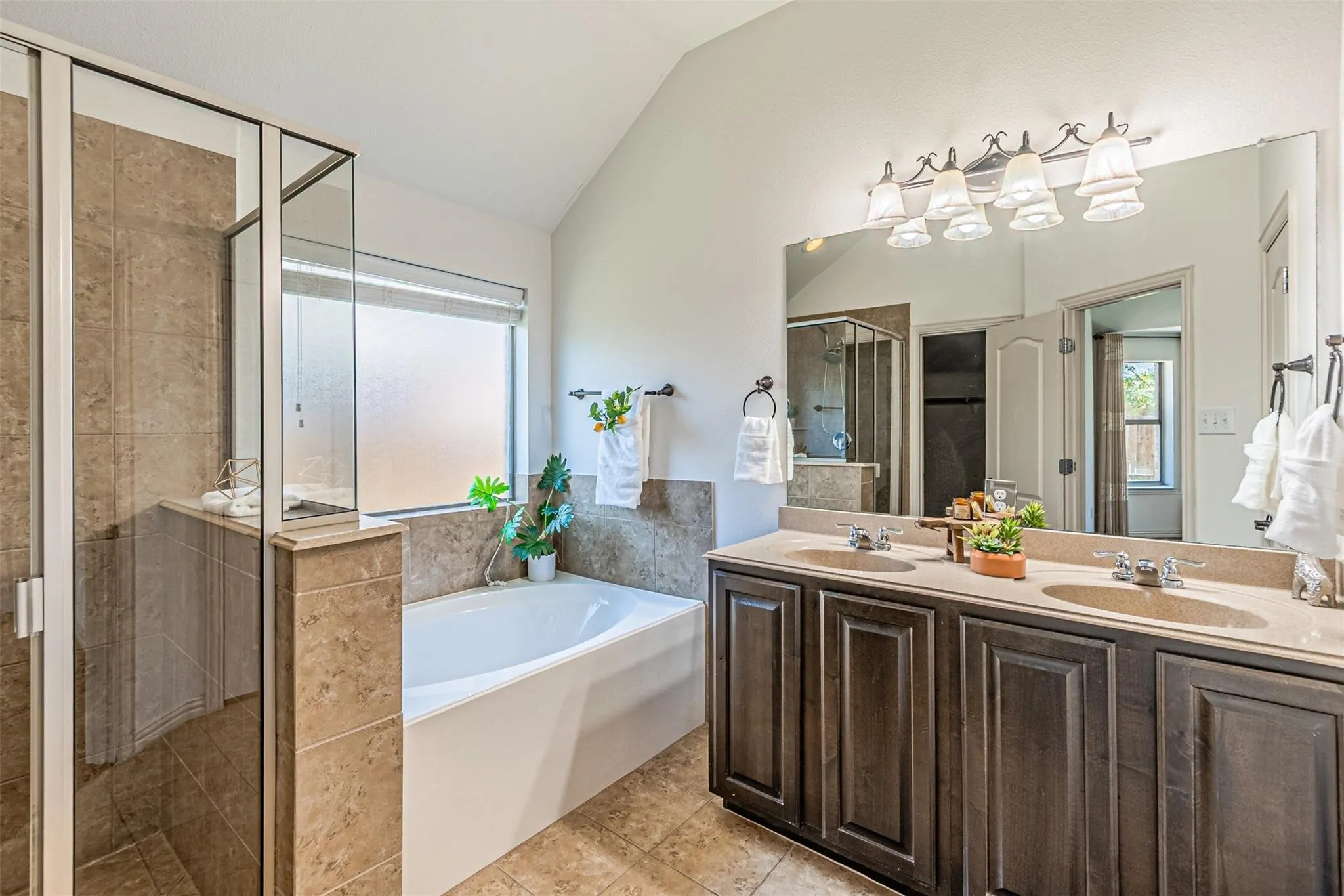 Dual vanity with stone-finish countertop and dark wood-finish cabinetry