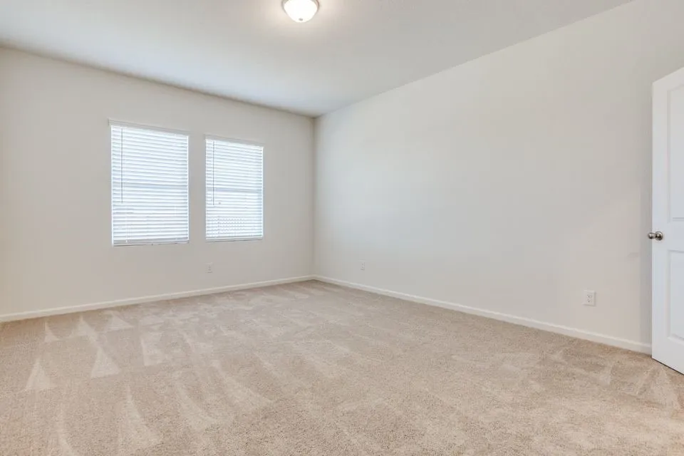 Neutral wall paint and carpeted flooring