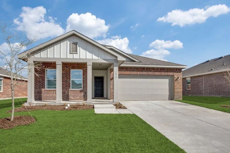 Brick exterior with vertical siding accents, covered entry, and an attached two-car garage