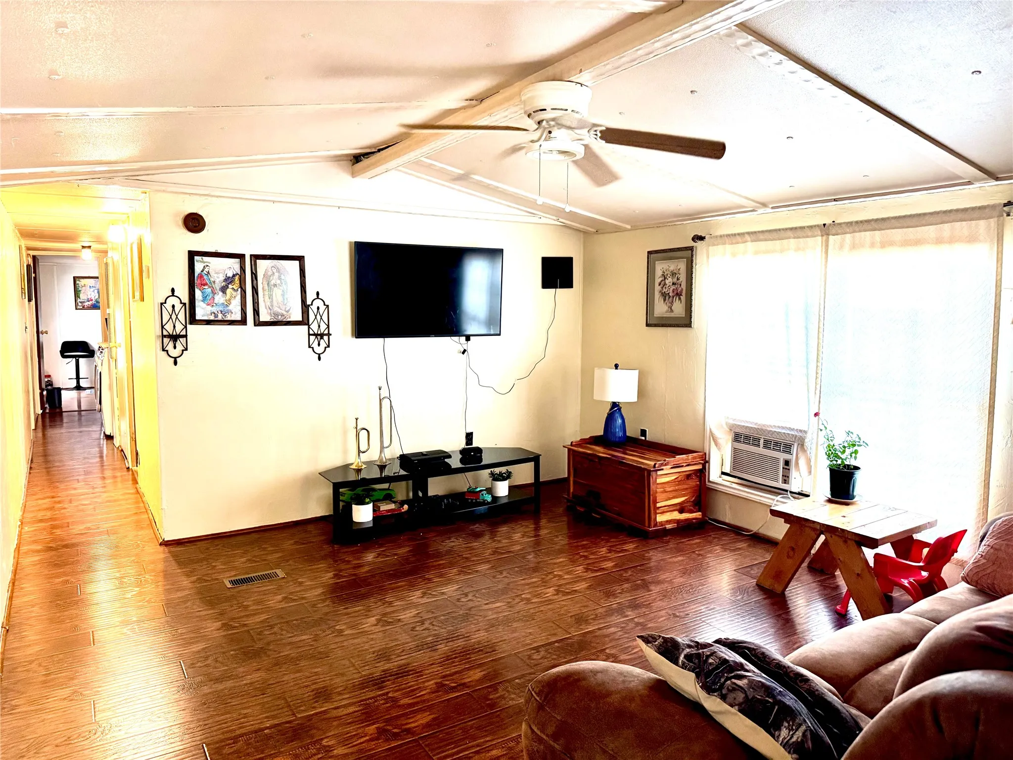 Ceiling fan with light fixture, and window-mounted air conditioning unit