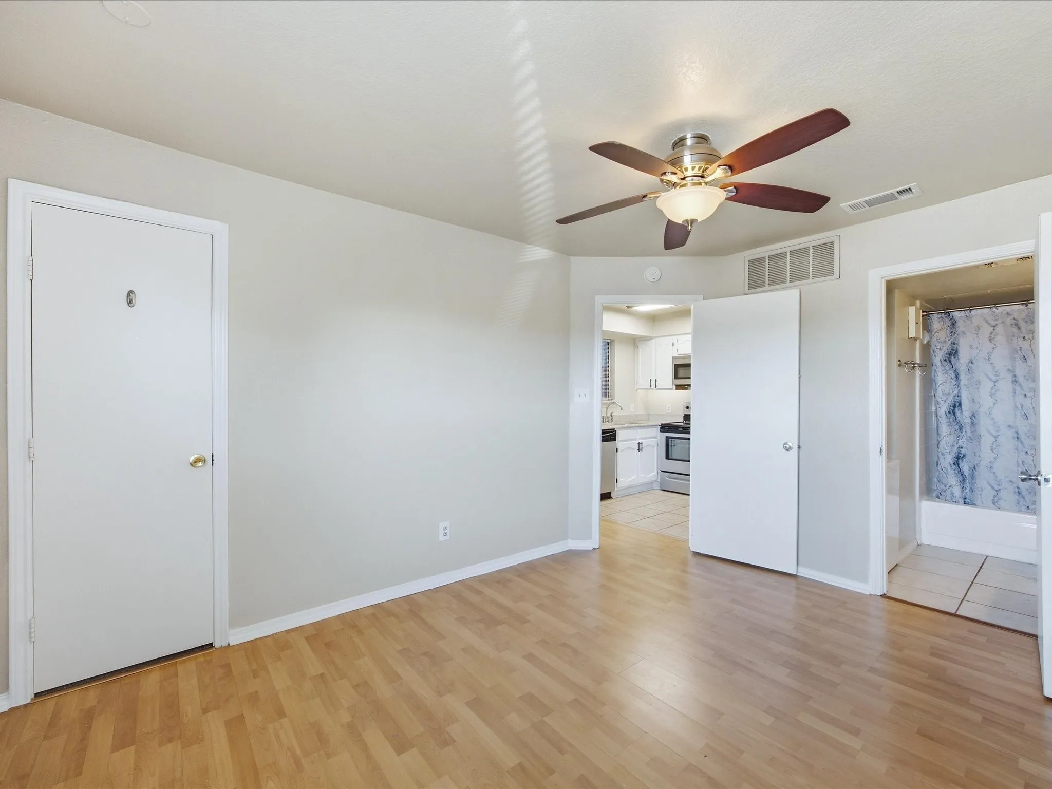 Wood-finish flooring with a ceiling fan light fixture
