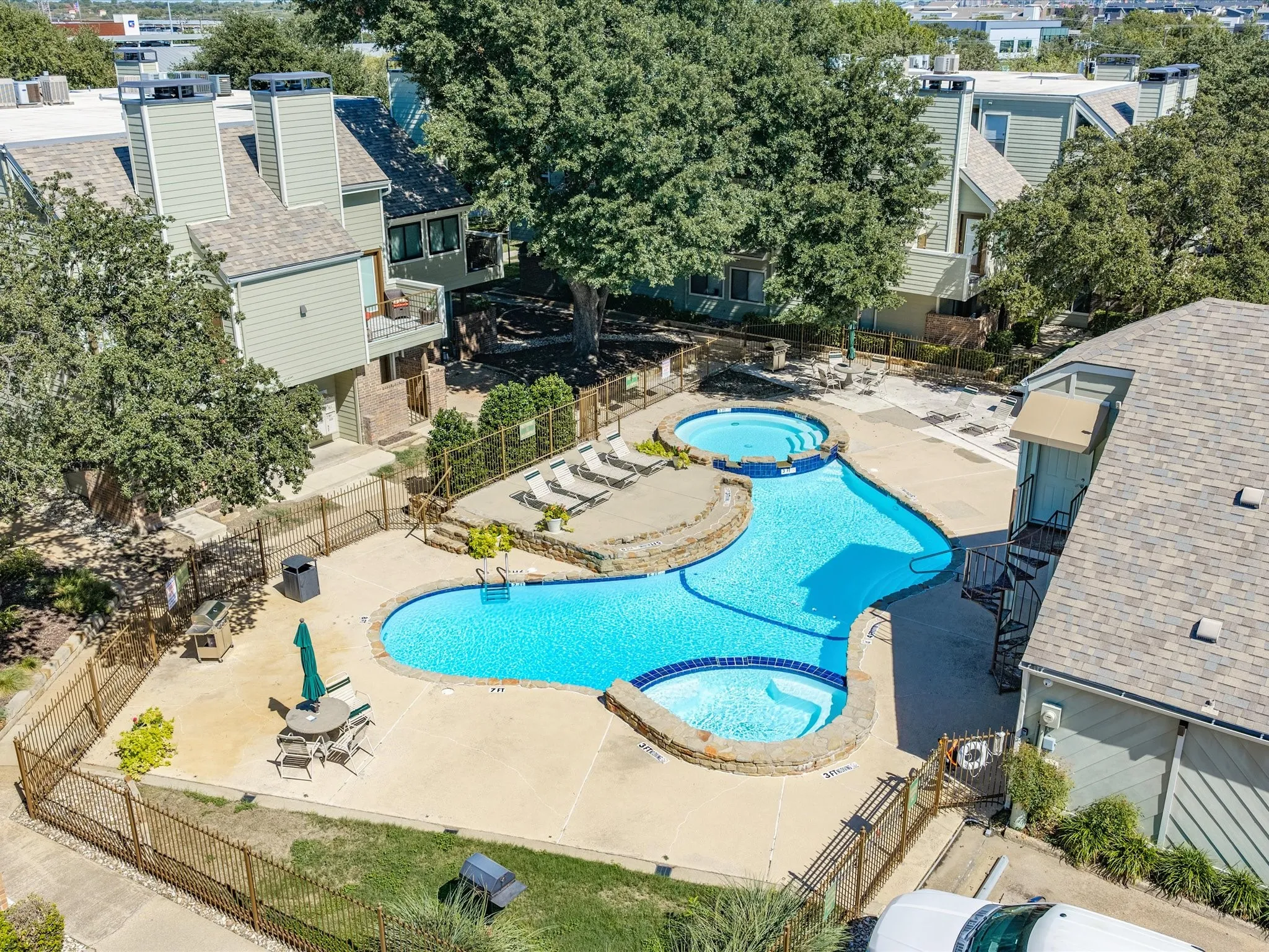 Resort-style pool with integrated spa and concrete surround