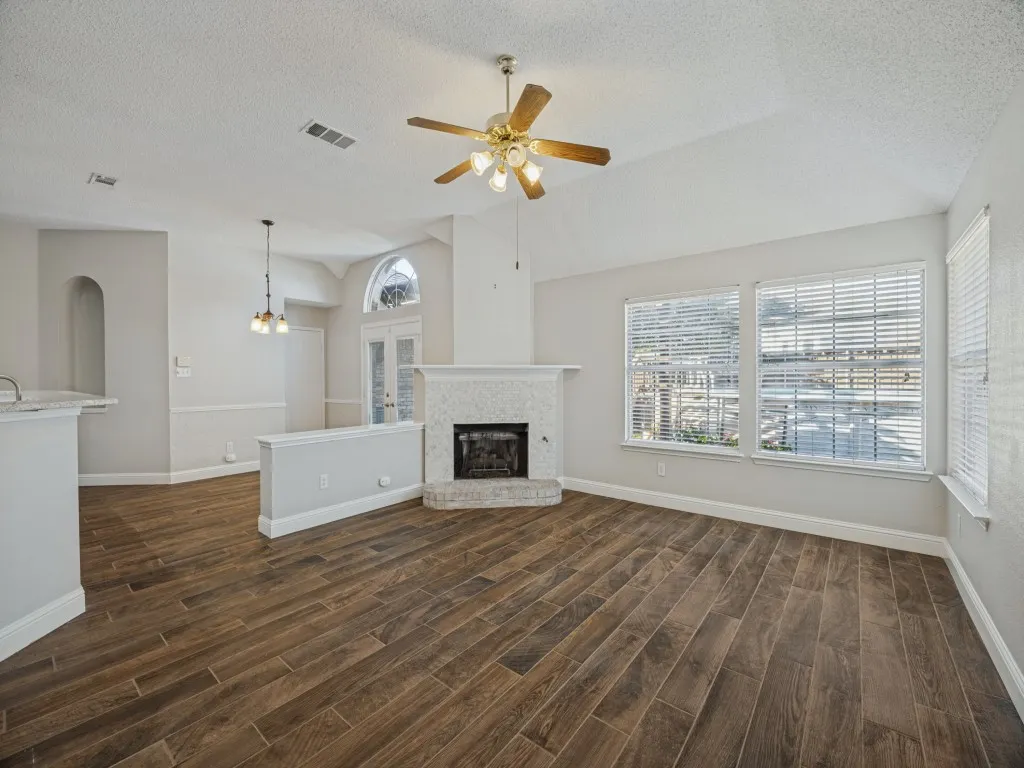 Living room with fireplace and abundant natural light