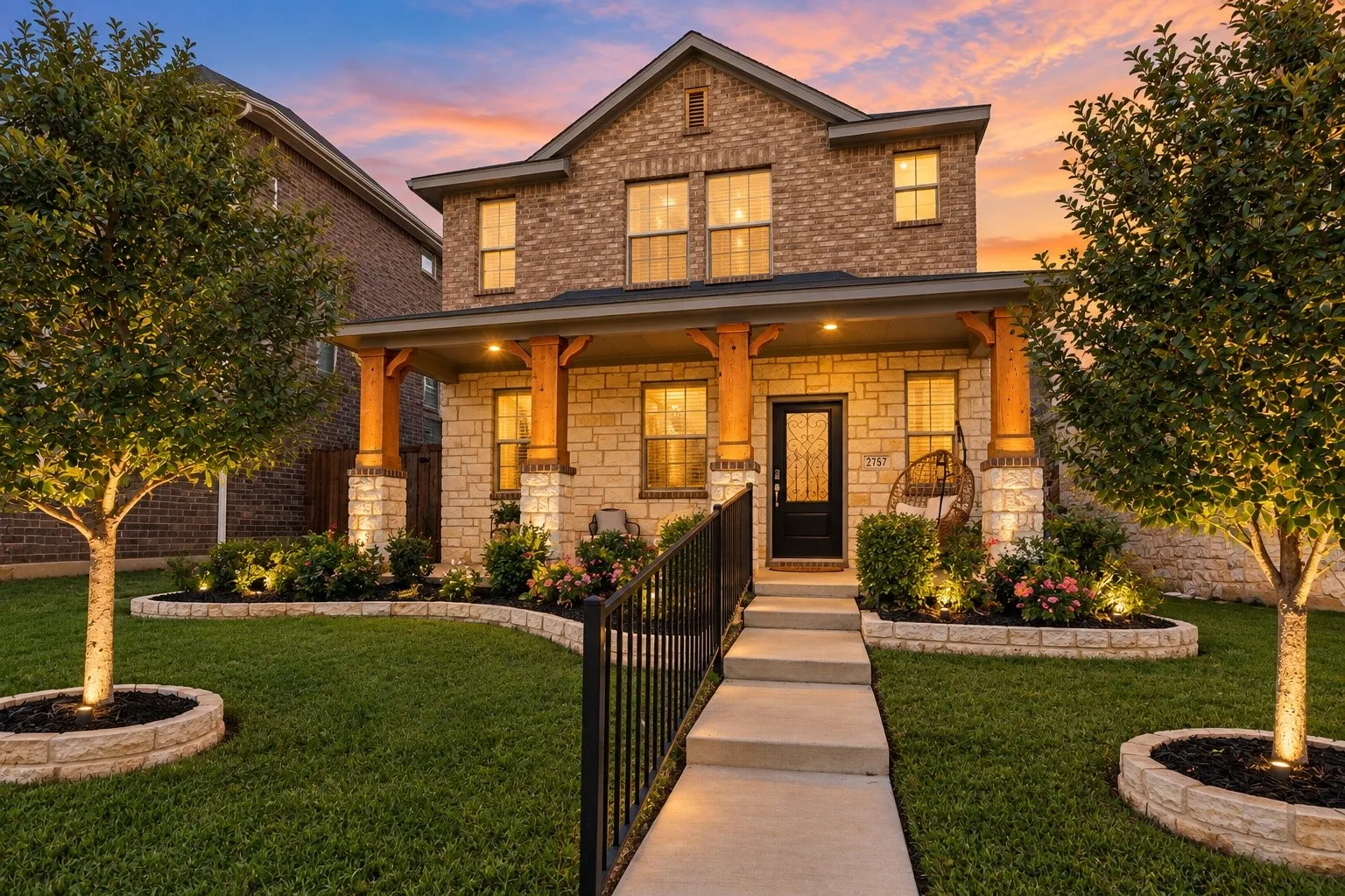 Stone and brick façade with a covered front porch featuring wood columns and stone bases