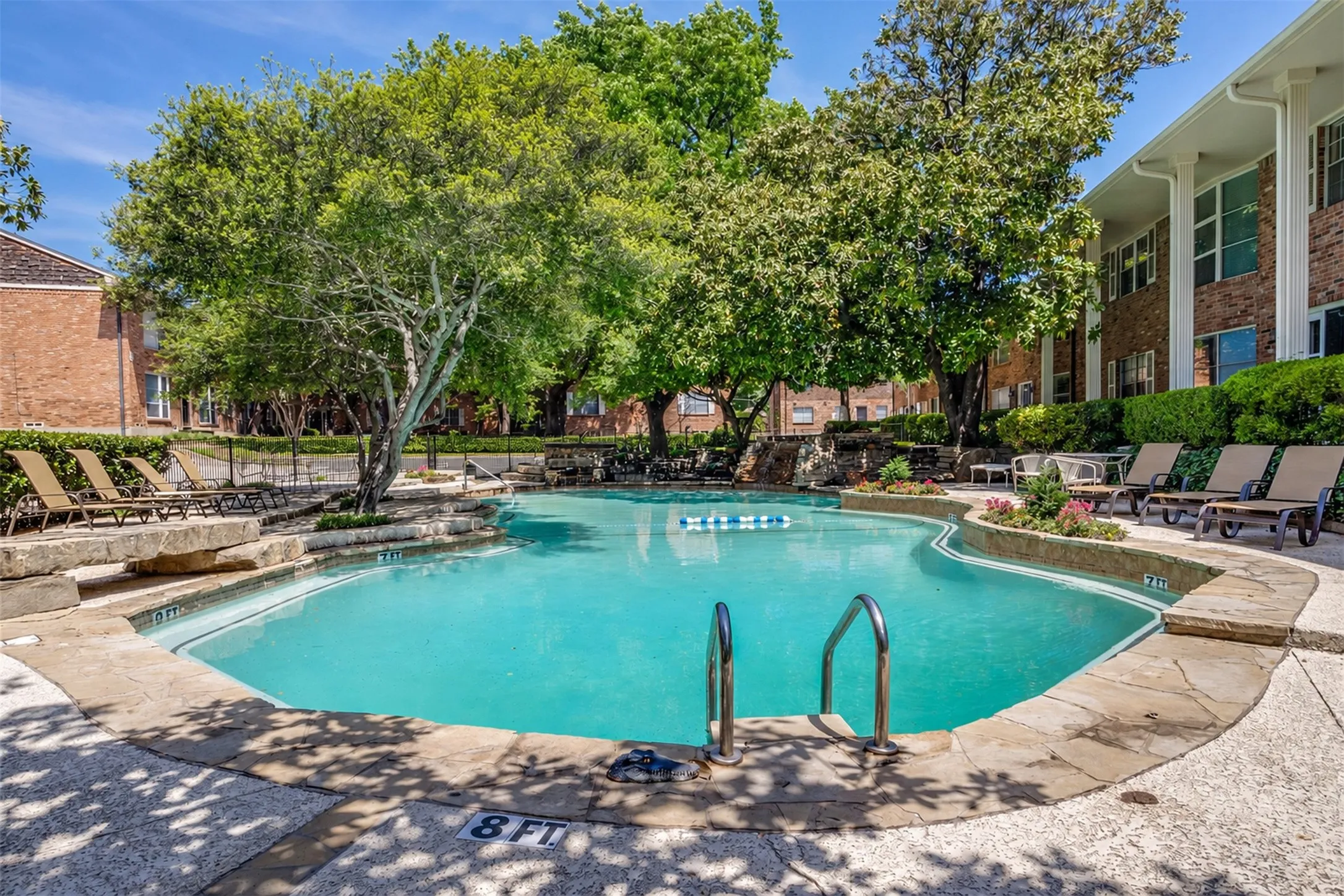 Resort-style pool with natural stone coping and integrated landscaping