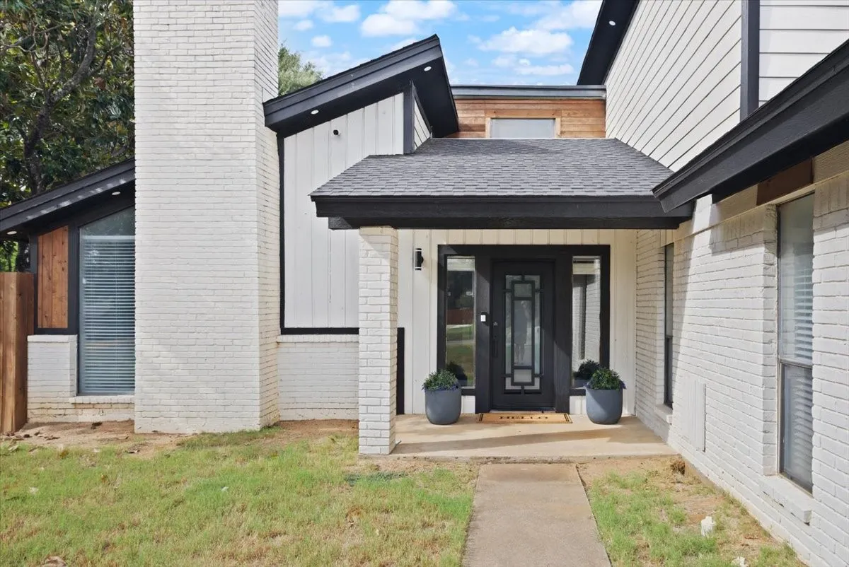 Covered front porch and a beautiful iron door