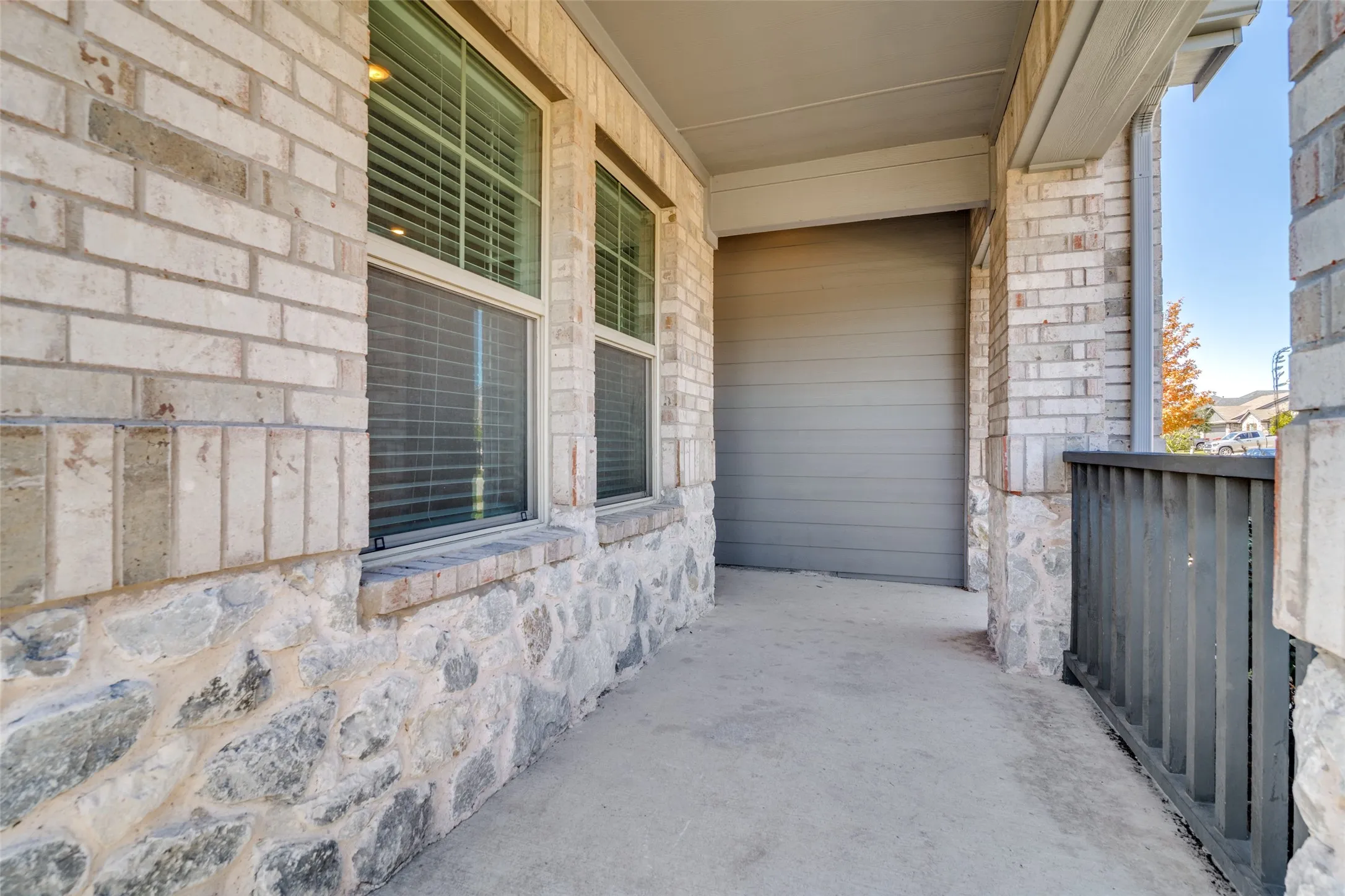 Brick and stone veneer exterior with a covered entry