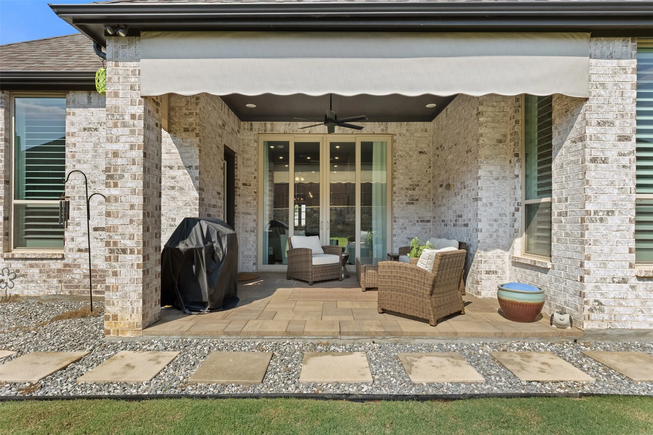 Covered patio featuring a ceiling fan and a retractable awning