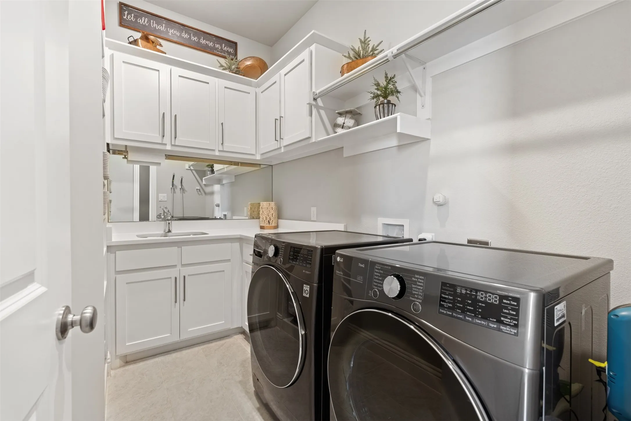 Laundry room with sink and built-in cabinets