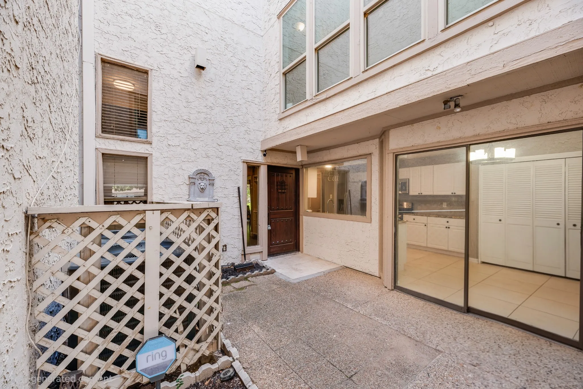 Concrete patio with stucco exterior and sliding glass doors