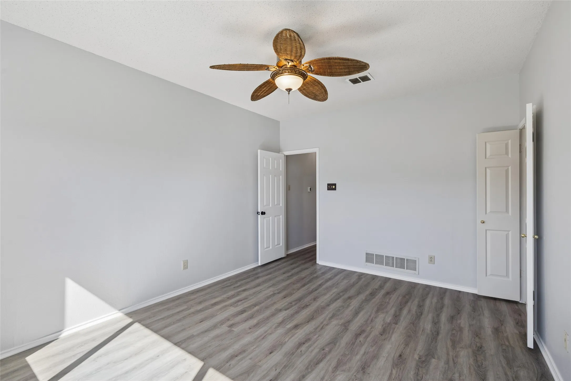 The primary bedroom is tucked away from the main living area.