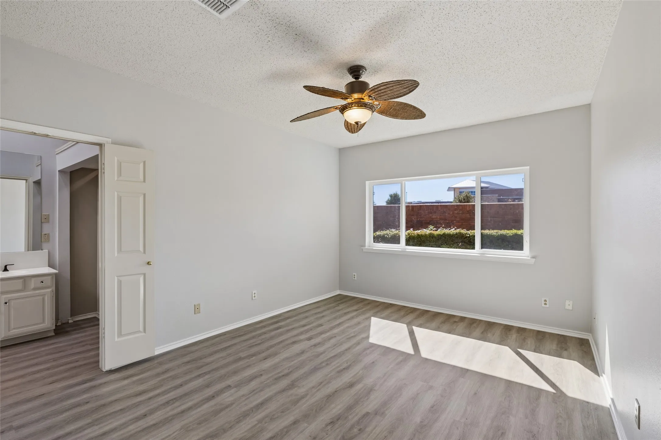 The first-floor primary bedroom offers privacy and beautiful natural light and an ensuite primary bath.