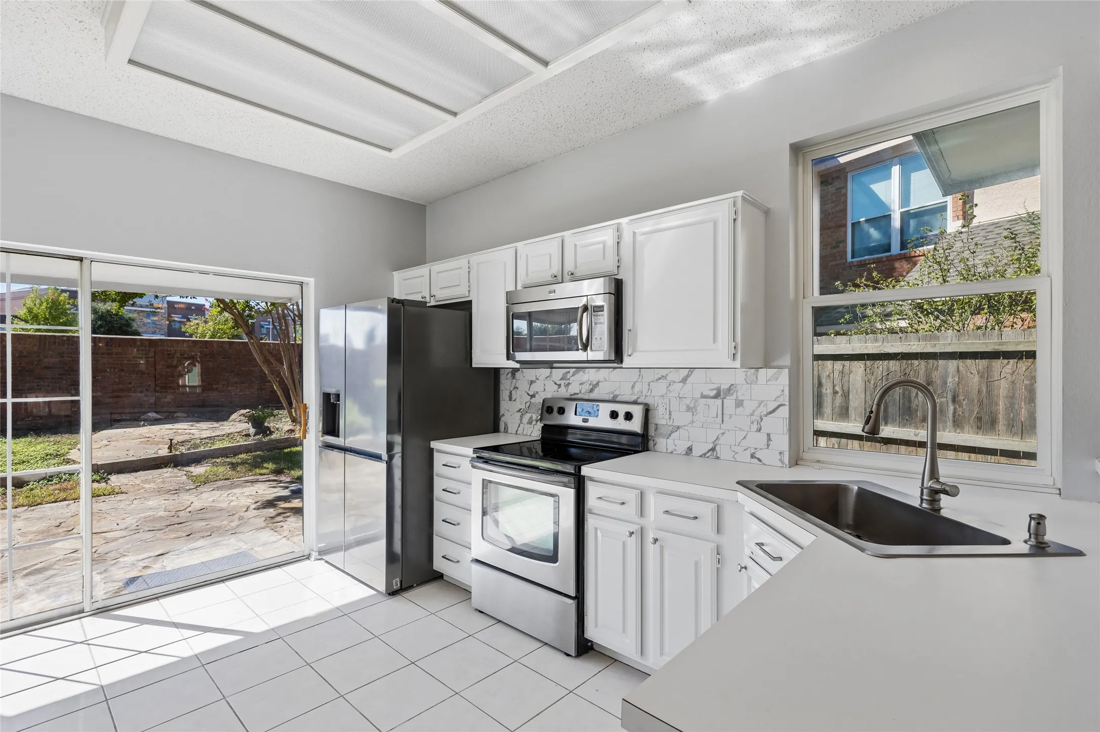 Easy care tile flooring complements the luxury vinyl flooring, cabinets and countertops.