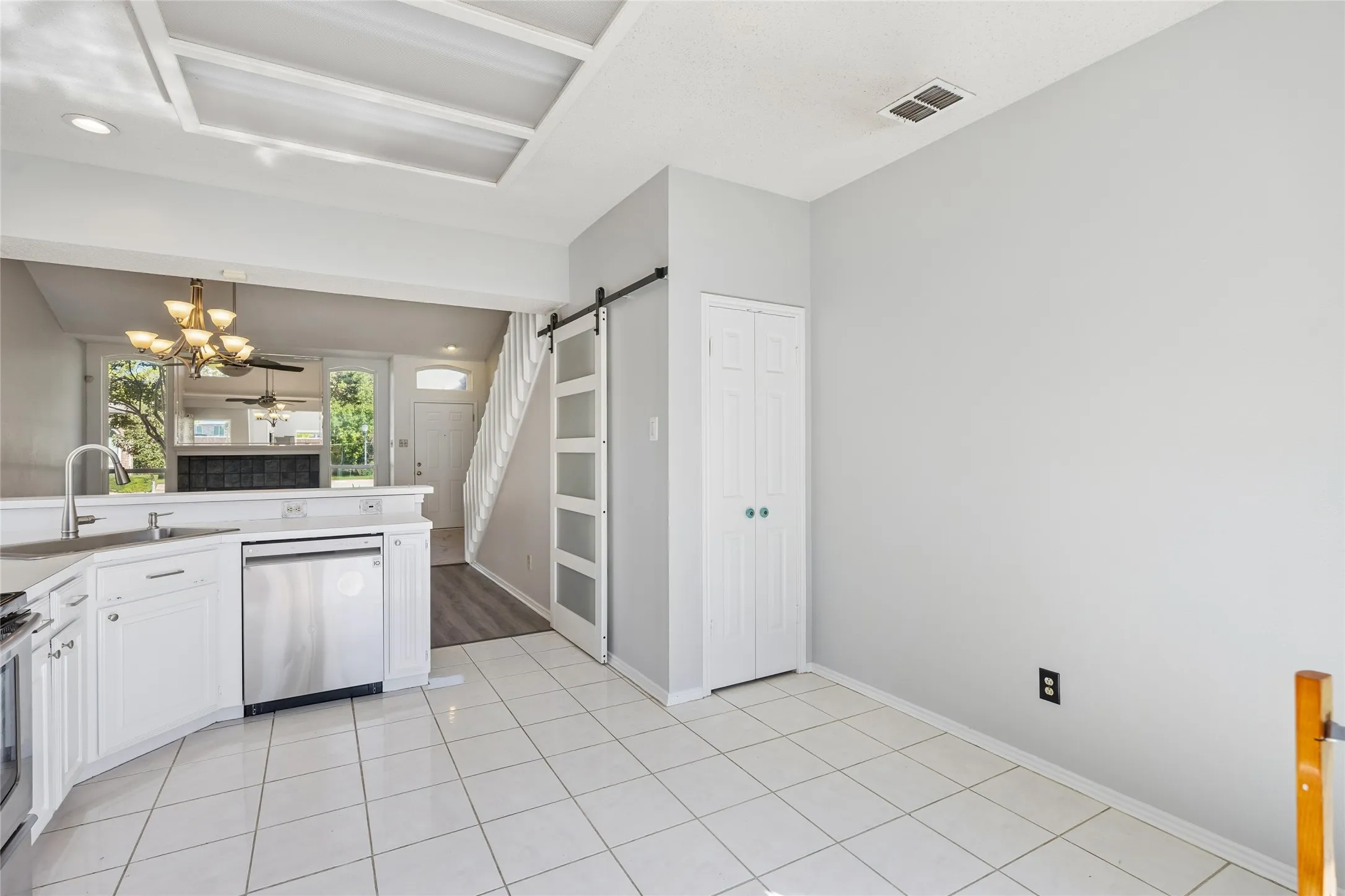The eat-in kitchen also features a pantry and additional storage under the staircase and has a barn-door closure.