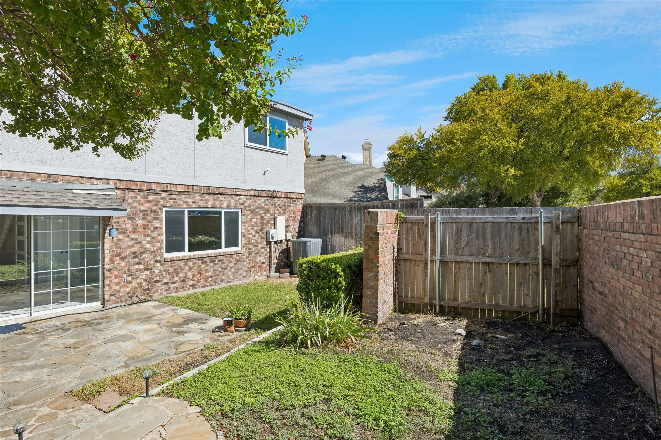The backyard also offers a brick and wooden fence for privacy.