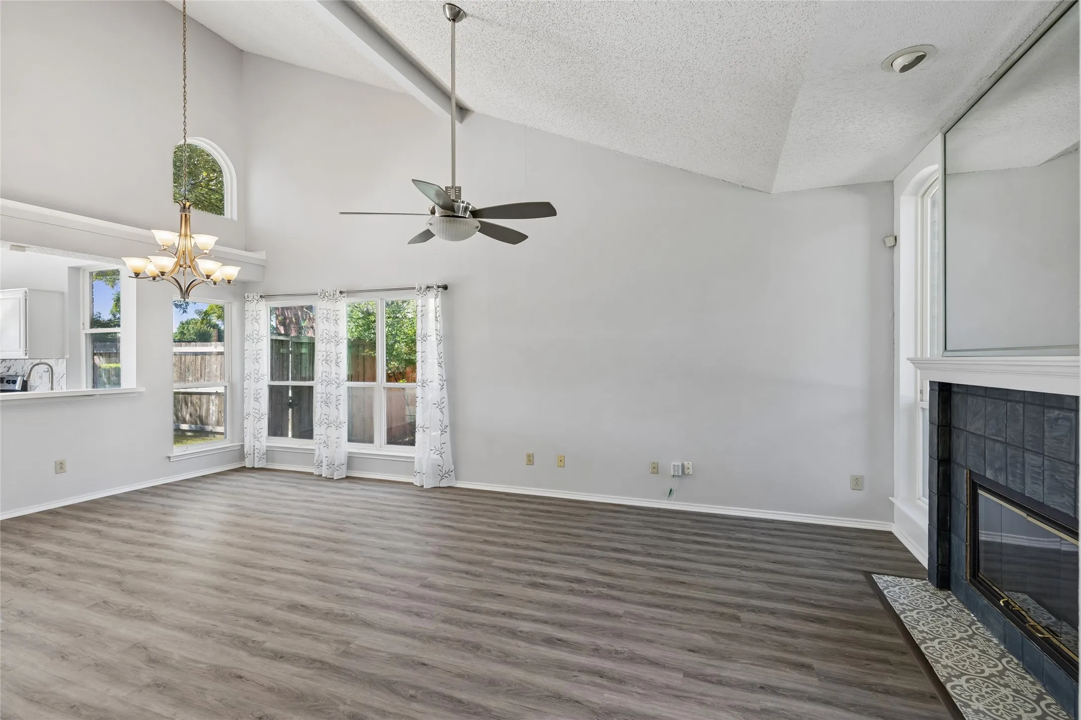 You are greeted by a large open floor plan with soaring ceiling and easy-care luxury vinyl flooring.