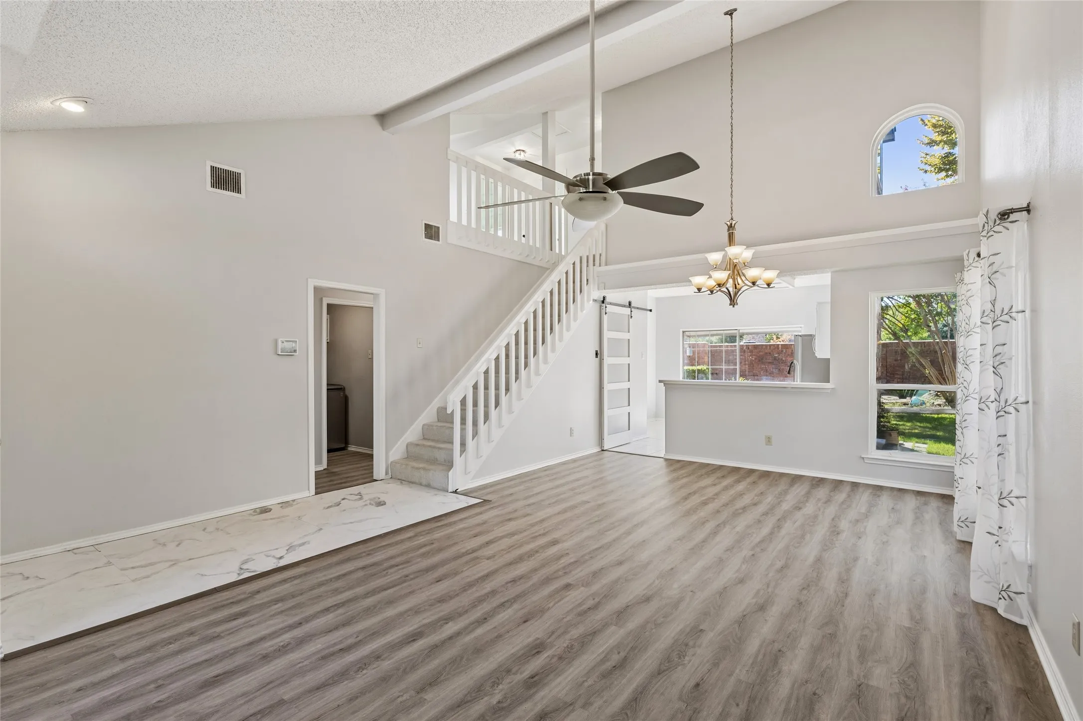 Living room / dining room combination with staircase leading to a relaxing loft and 2 split bedrooms and shared full bath.