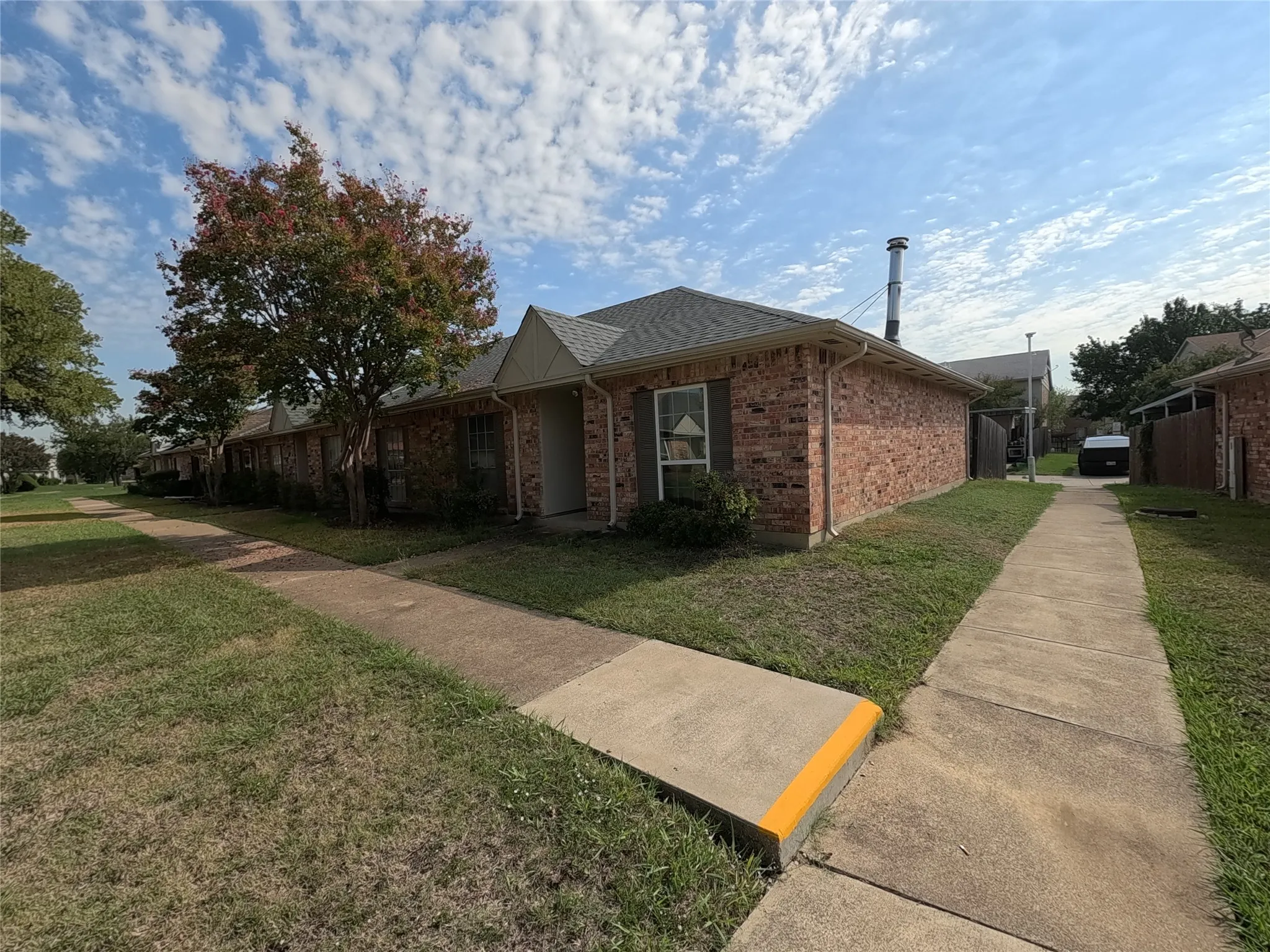 Brick exterior with a gabled roof and white trim