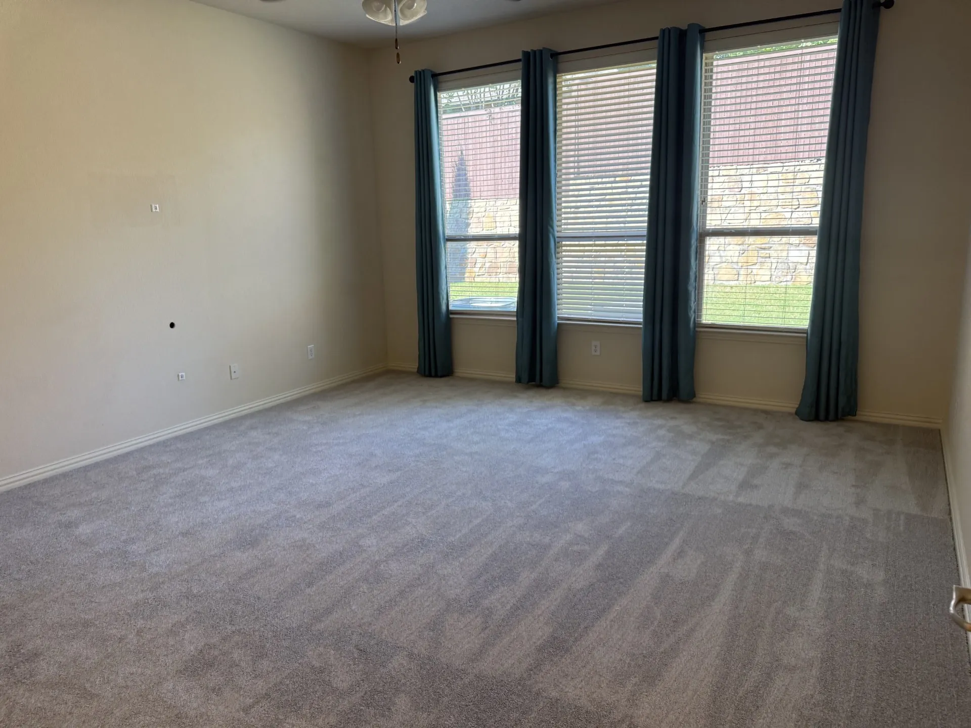 Spacious interior with neutral wall tones and light-toned carpeting
