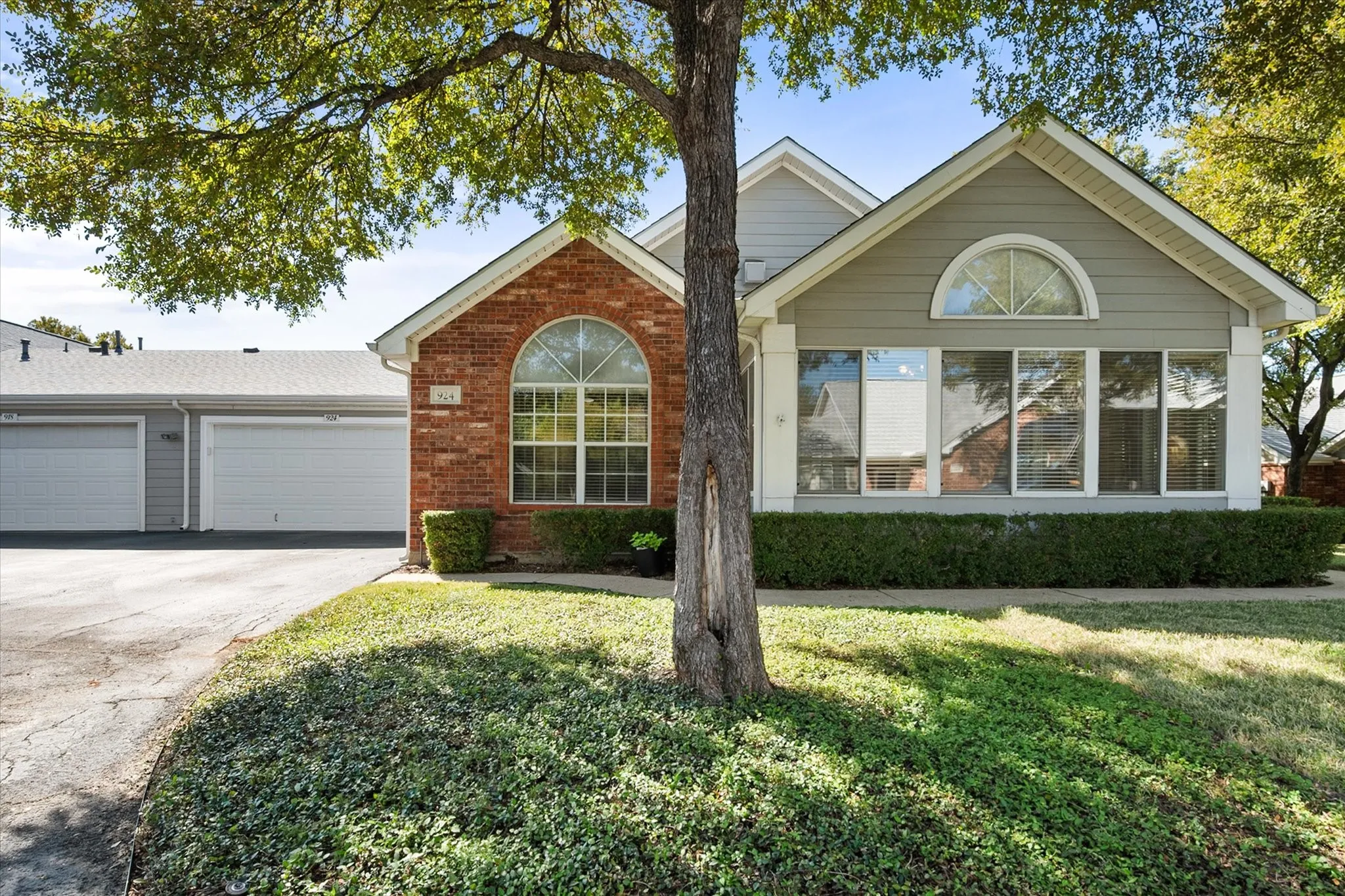 Brick and siding exterior with arched and rectangular windows