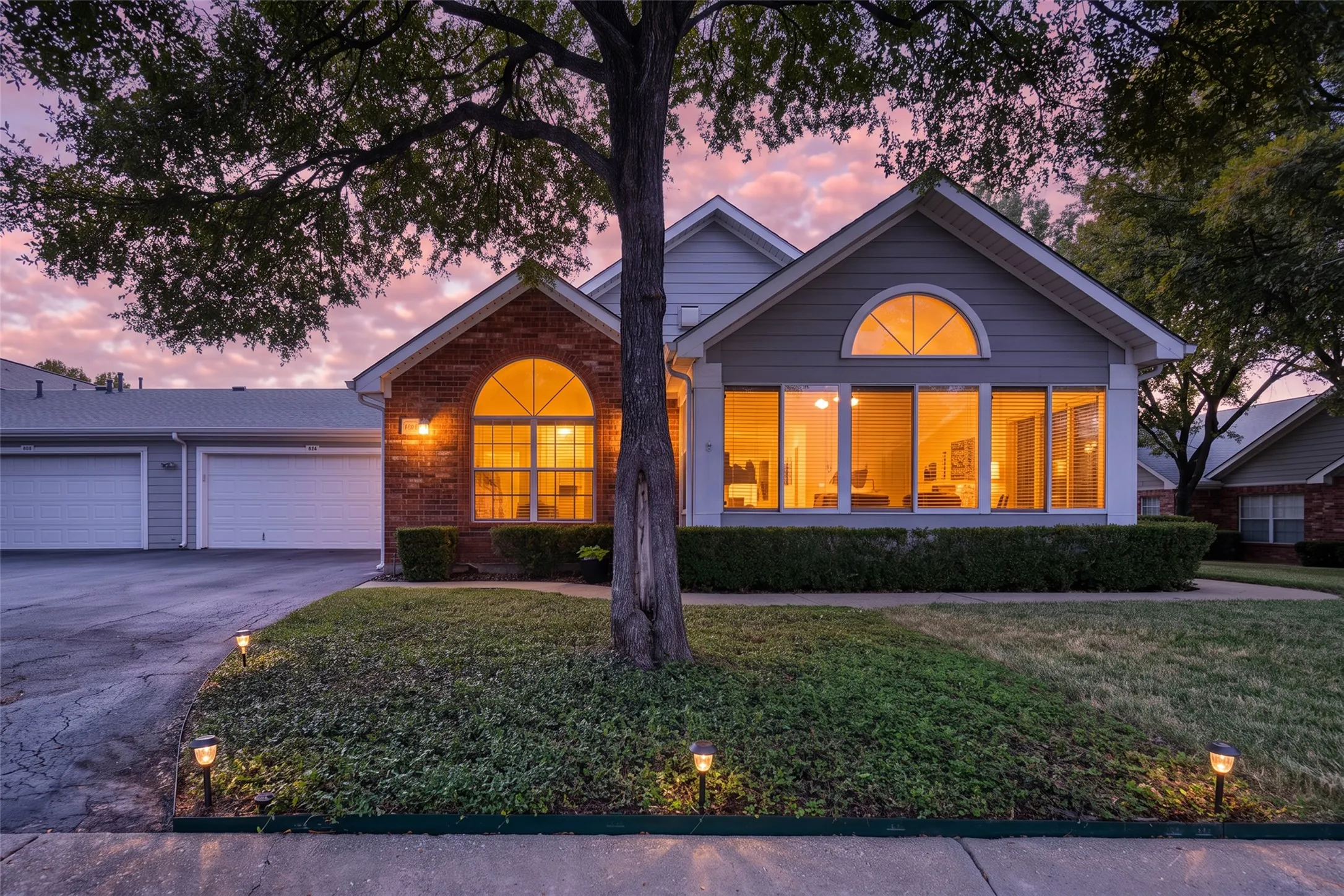 Brick and siding exterior with arched and rectangular windows